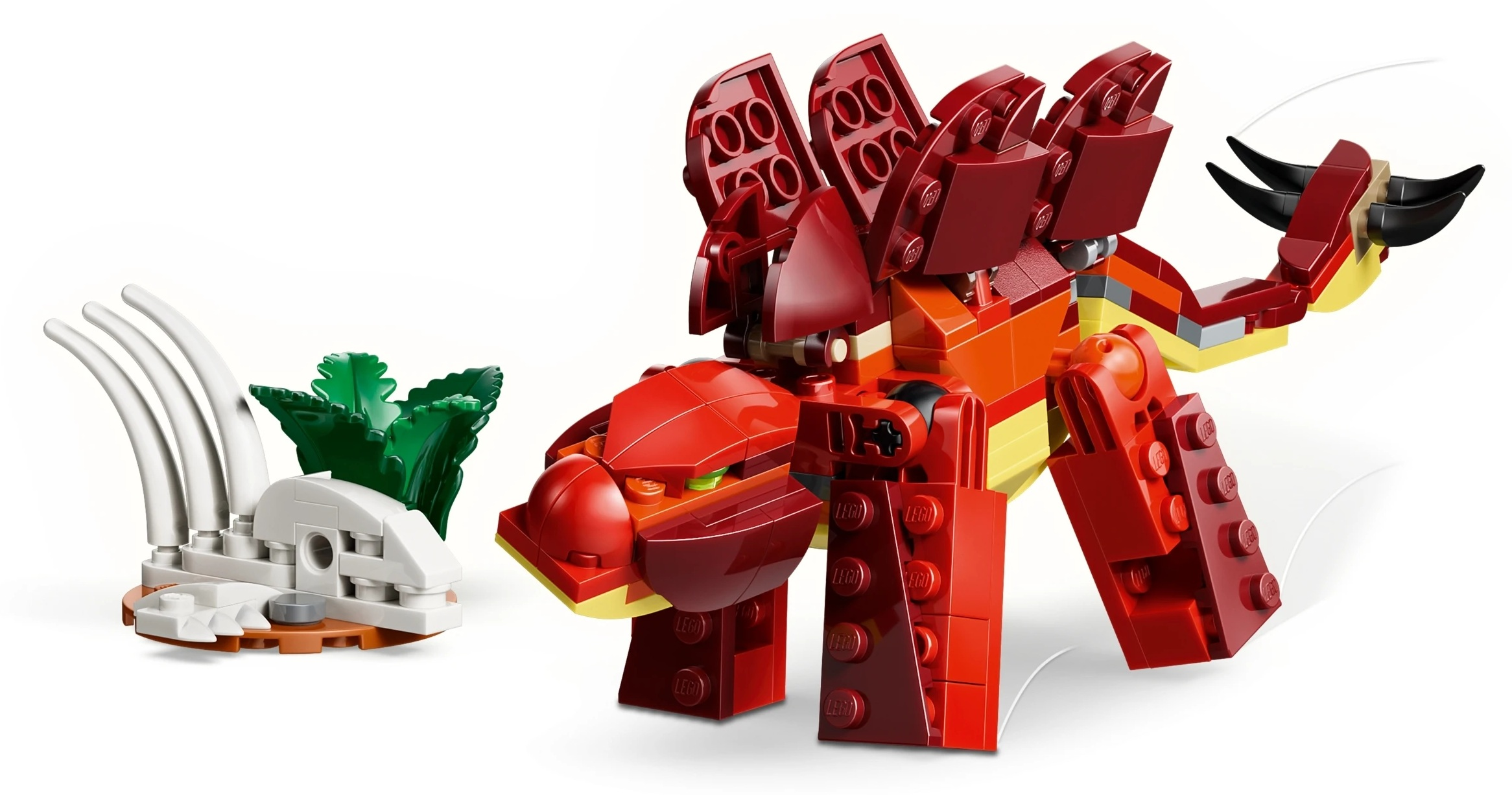 Czerwony dinozaur z klocków Lego stoi obok białego szkieletu z klocków Lego i zielonych liści.