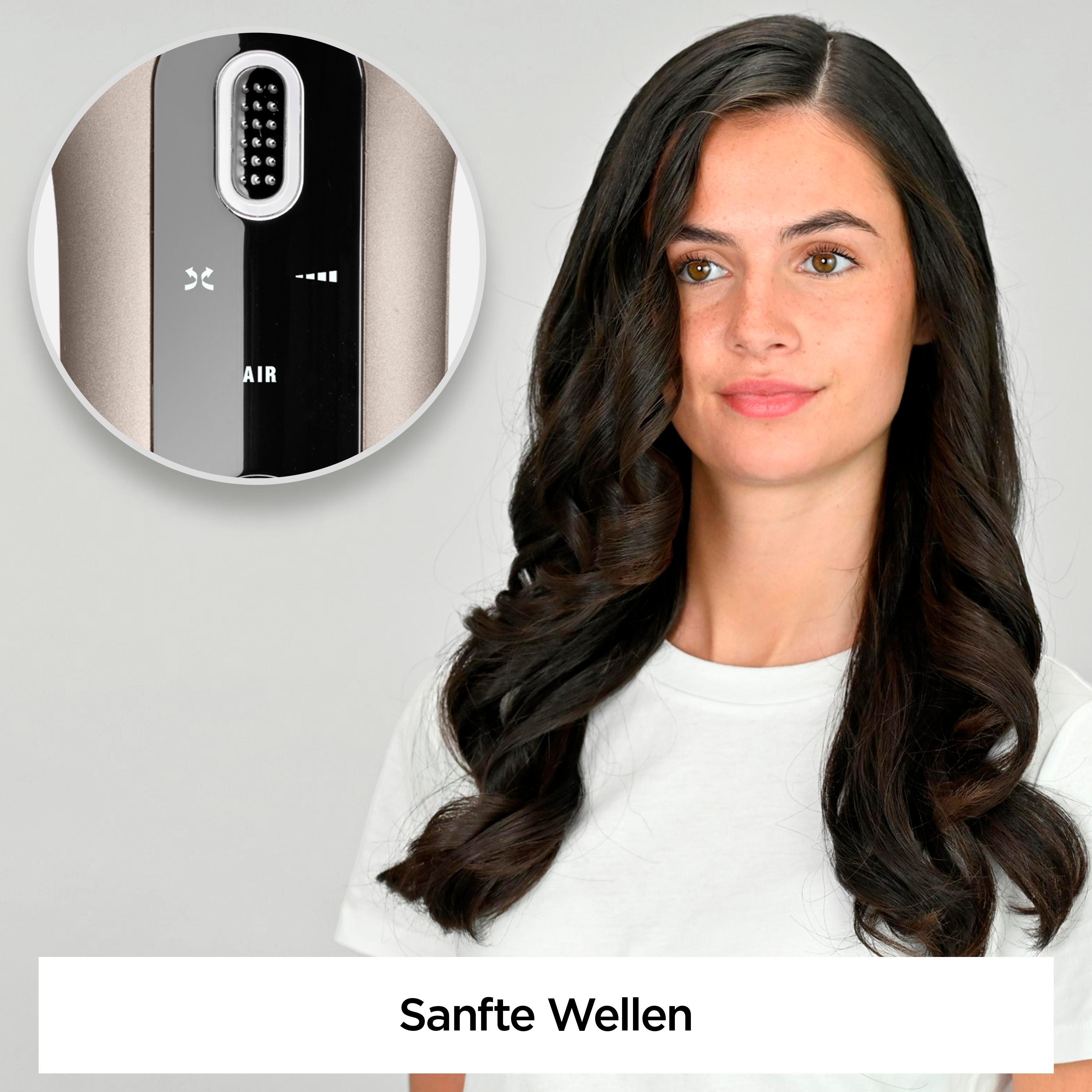 Frau mit braunen Haaren, die sanfte Wellen stylt. Nahaufnahme des Geräts.