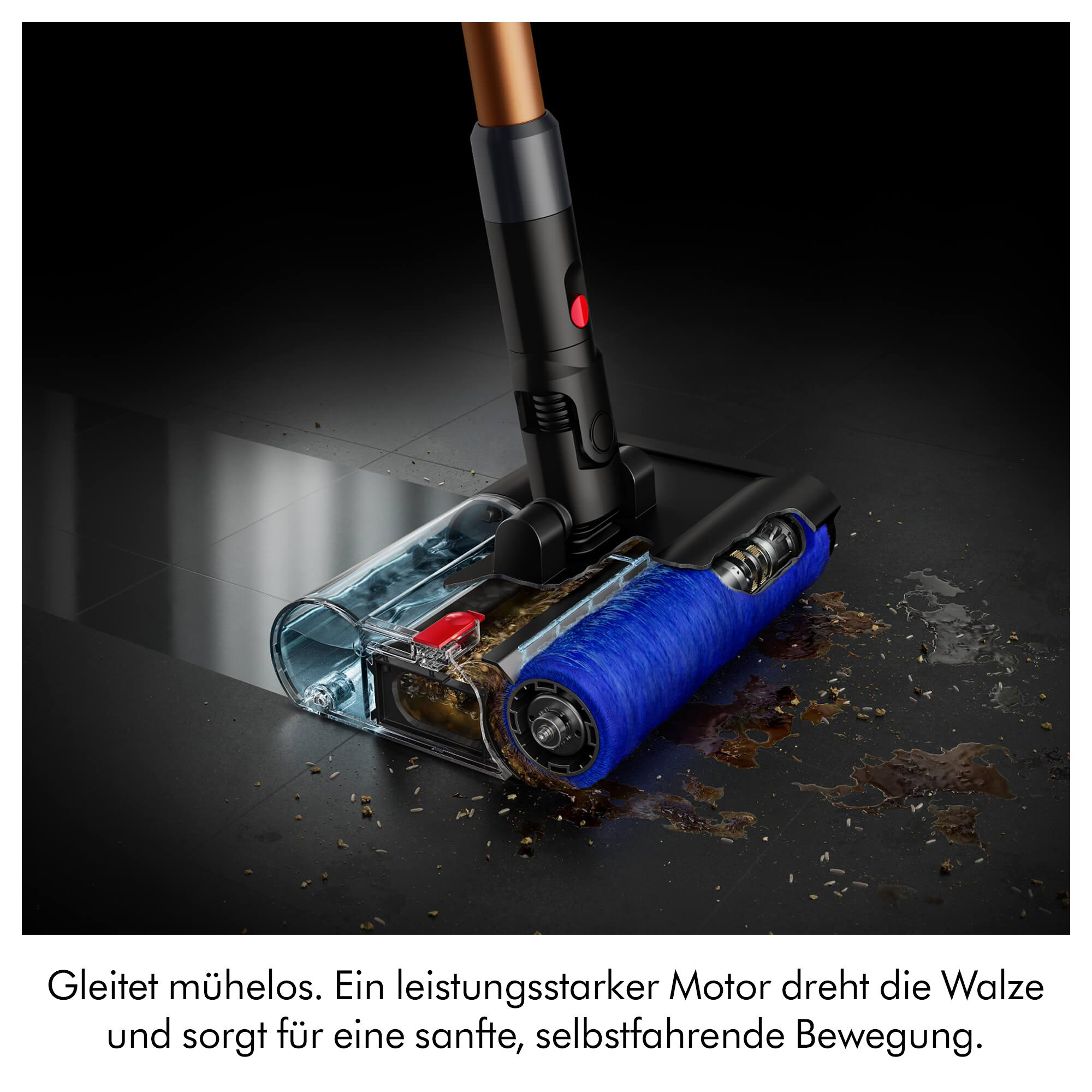 Ein blauer Bürstenkopf mit transparentem Behälter saugt Schmutz auf.