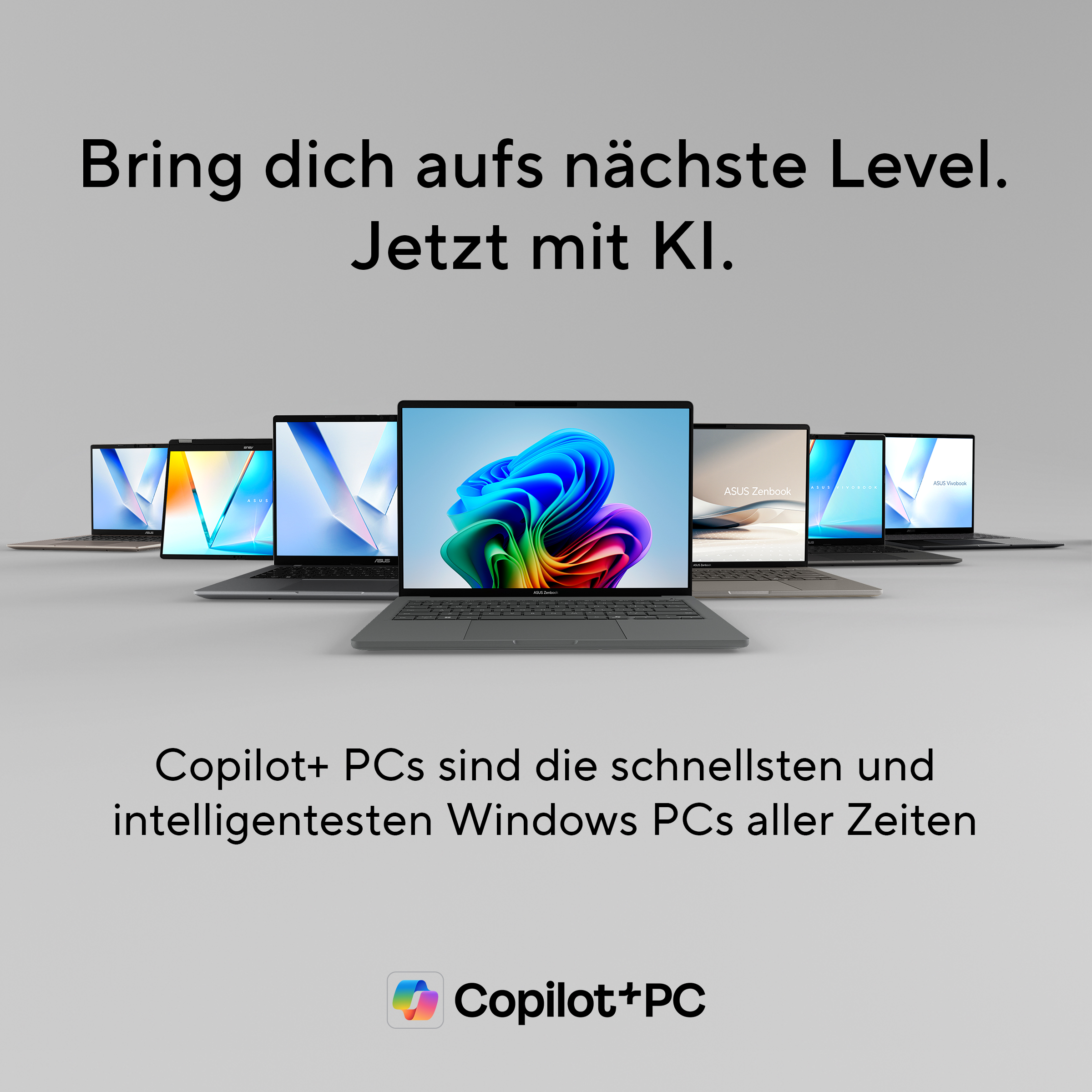 Mehrere Laptops nebeneinander, auf dem mittleren ist ein buntes Desktop-Bild.