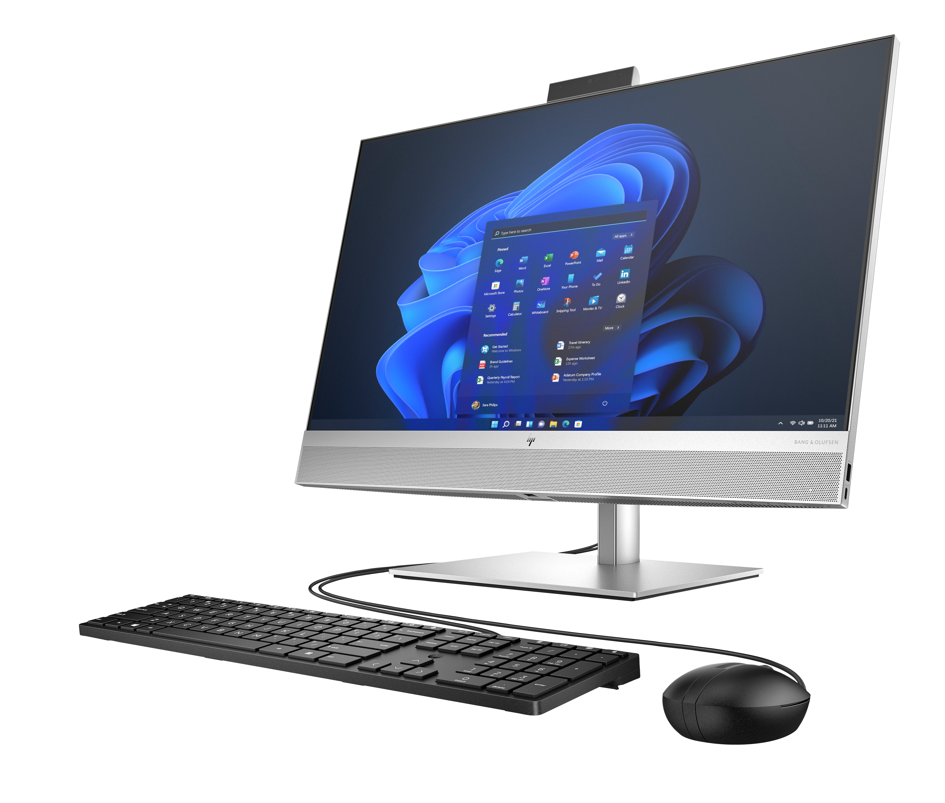 Ein silberner All-in-One-PC mit Tastatur und Maus auf schwarzem Hintergrund.