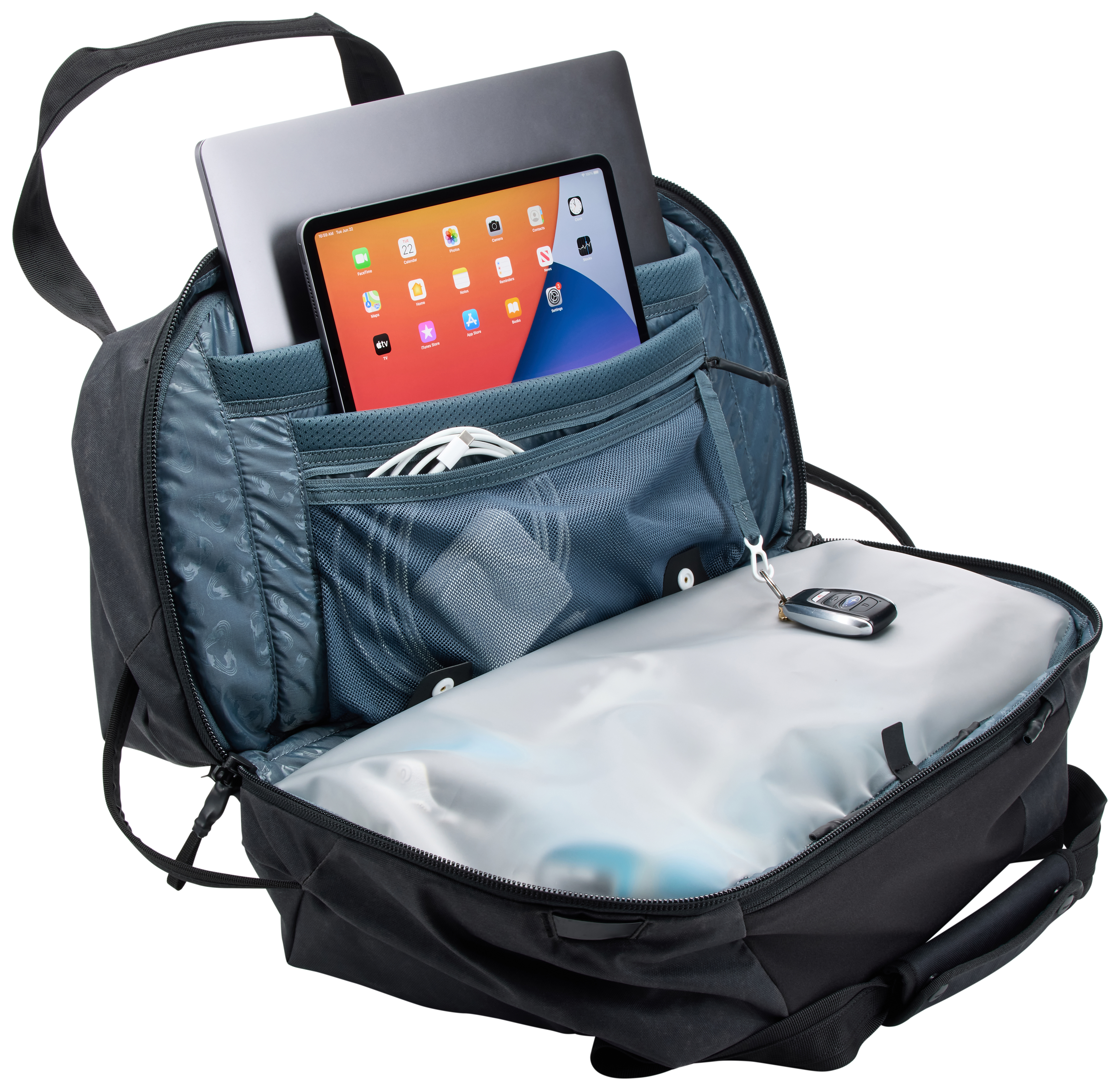 Açık siyah sırt çantası içinde dizüstü bilgisayar, tablet, beyaz kablolar ve araba anahtarları.