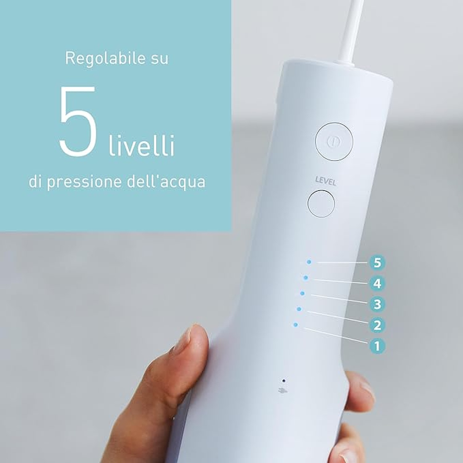 Un irrigatore orale bianco con 5 livelli di pressione tenuto da una mano.