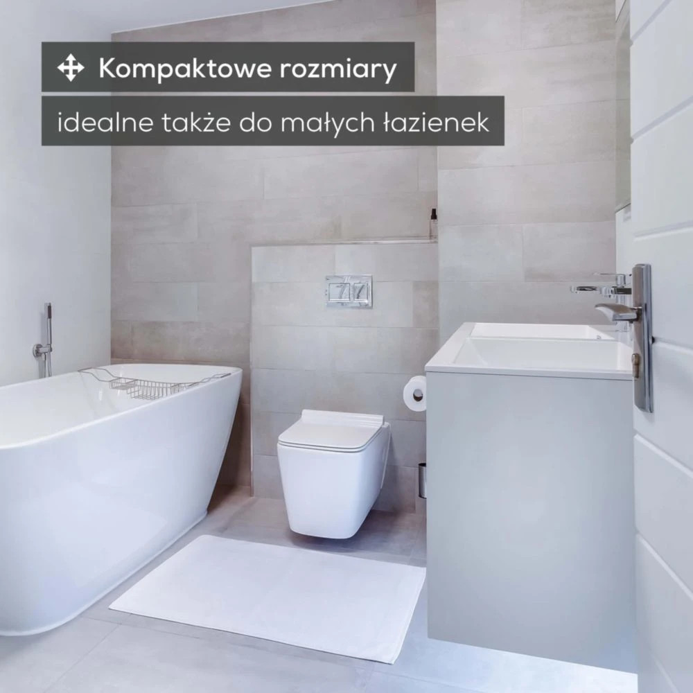 Nowoczesna łazienka z wanną wolnostojącą, toaletą, umywalką i uchwytem na papier.