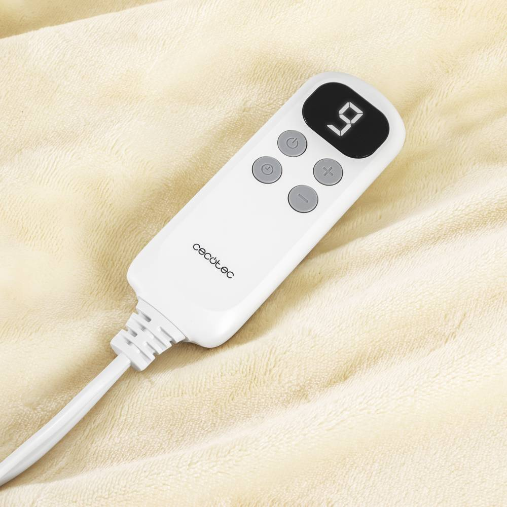Controlador blanco de manta eléctrica con pantalla LCD sobre una manta color crema.