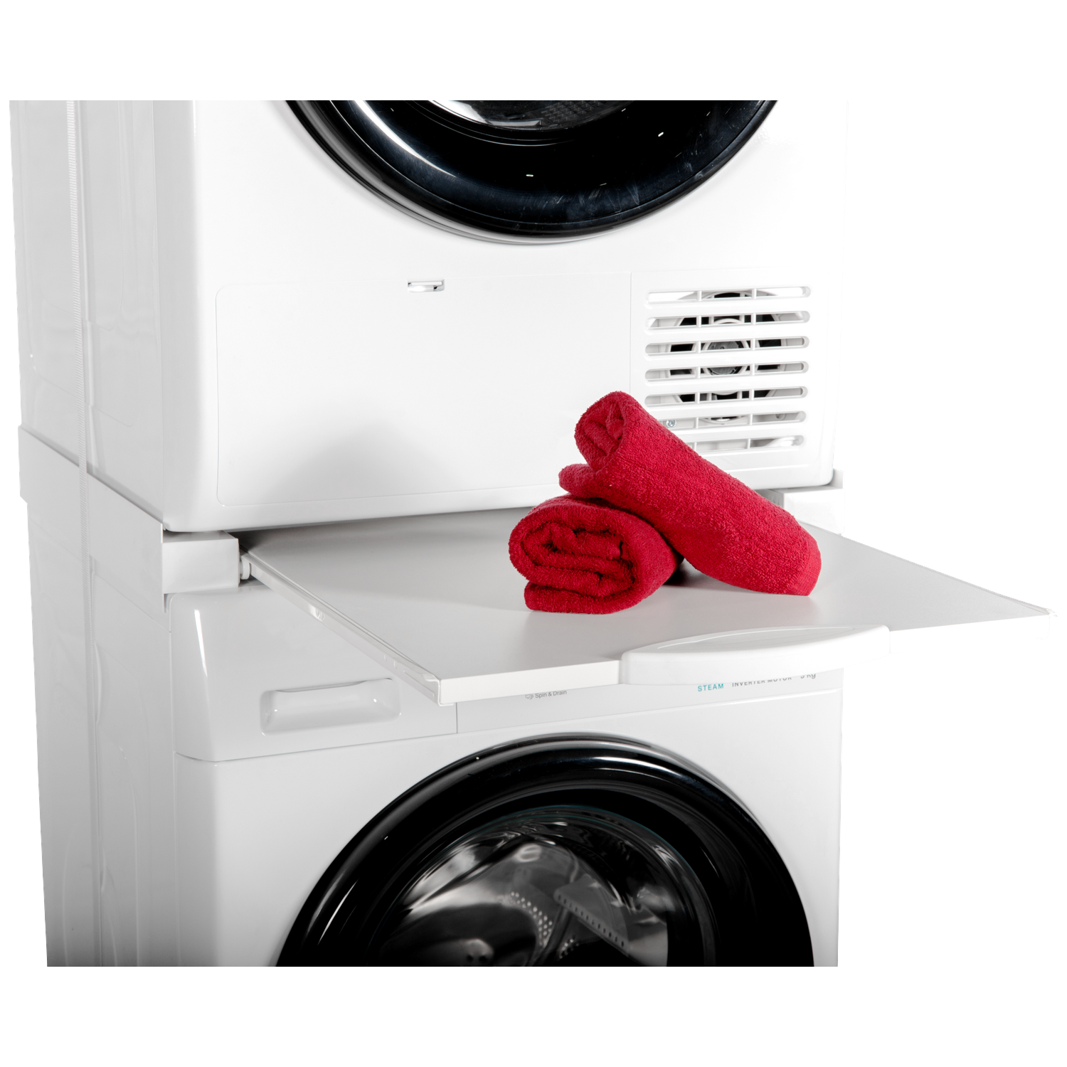 Two red towels lie on an extendable shelf between a washing machine and dryer.