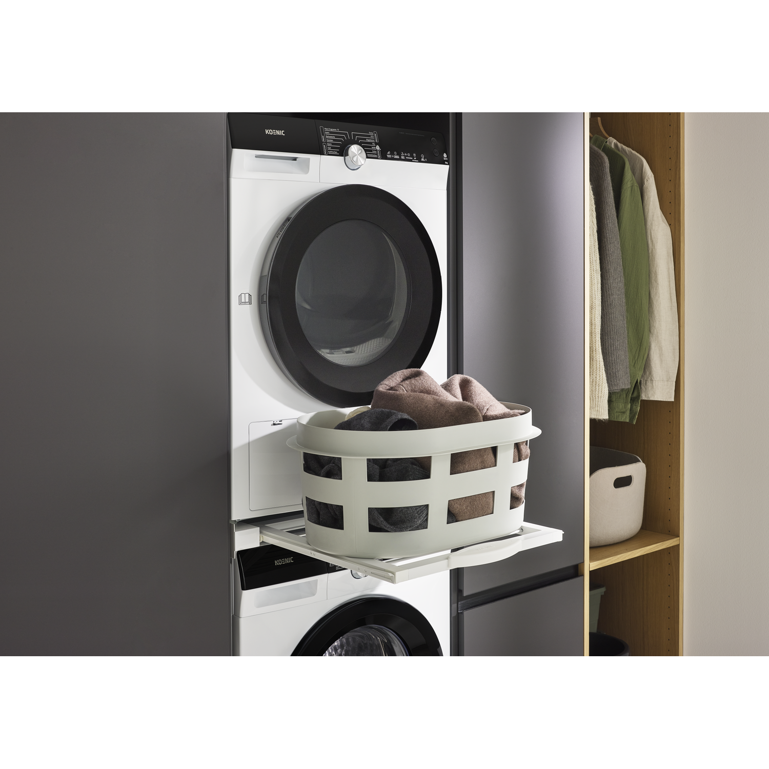 White washer-dryer combo with laundry basket and clothes in cabinet.