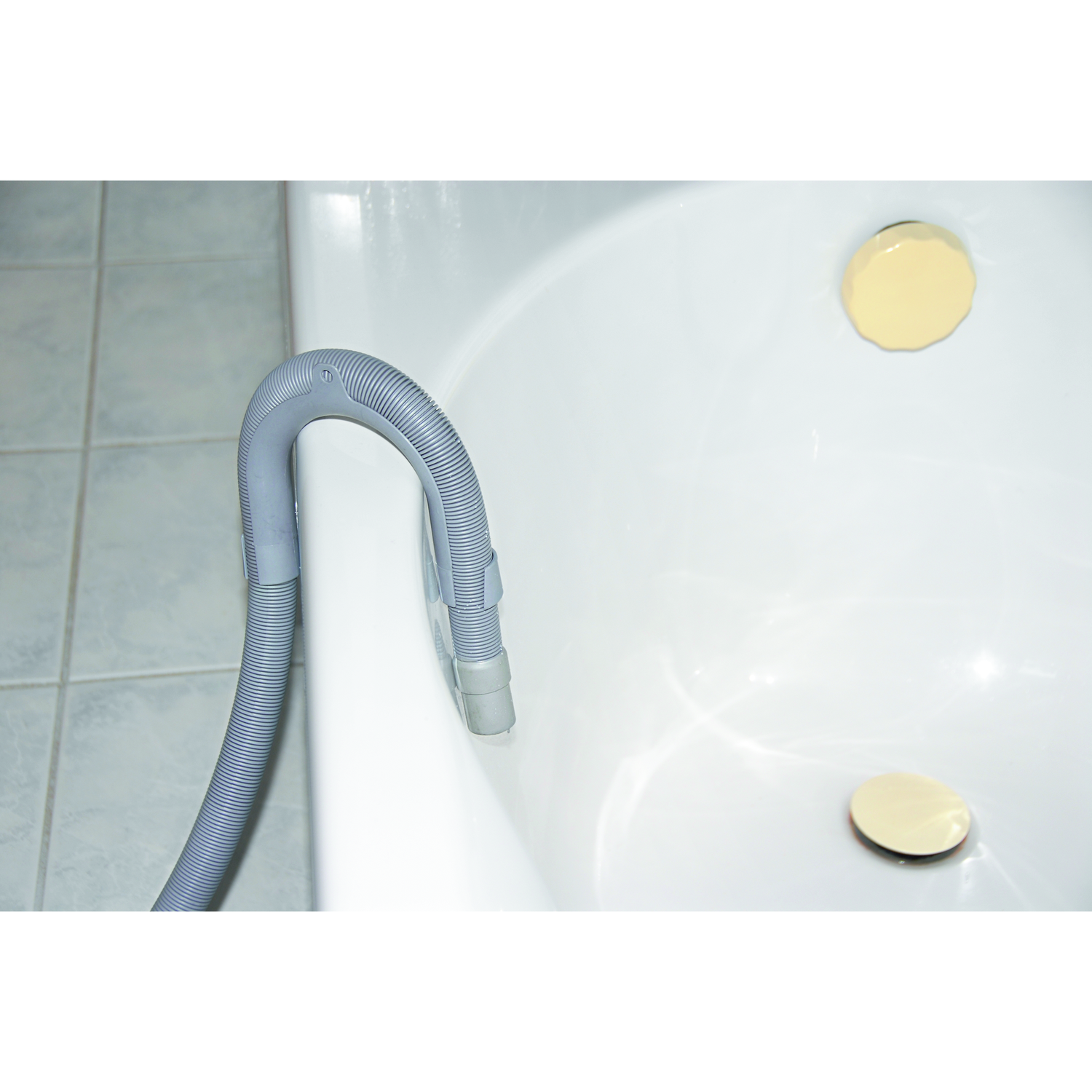 A gray hose extends over the edge of a white bathtub.