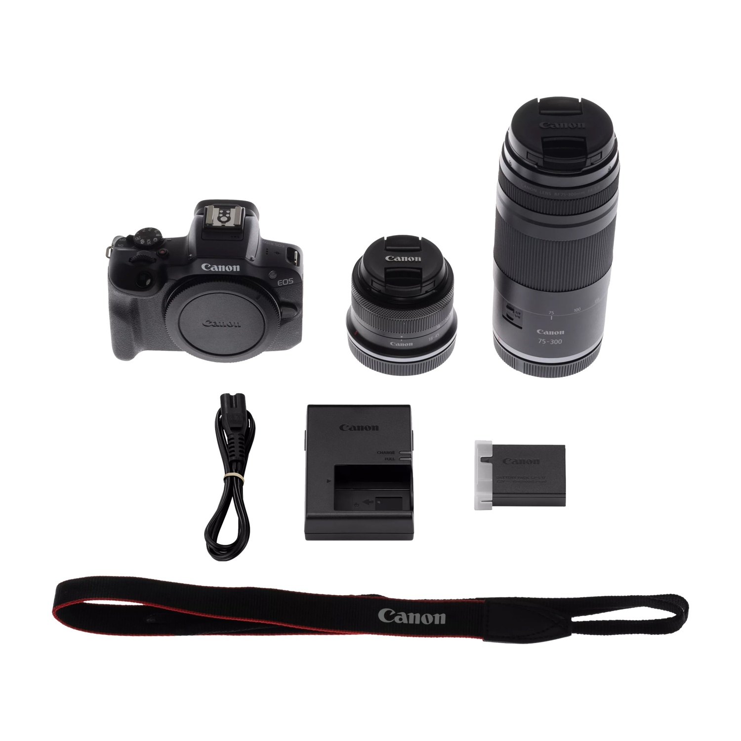Un kit fotocamera Canon EOS R con due obiettivi, caricabatterie e tracolla.