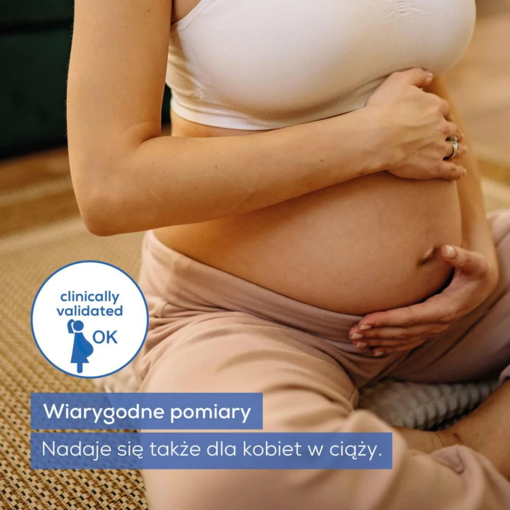 Ciężarna kobieta trzyma się za brzuch. Widoczny okrąg z napisem 'klinicznie zatwierdzony OK'.