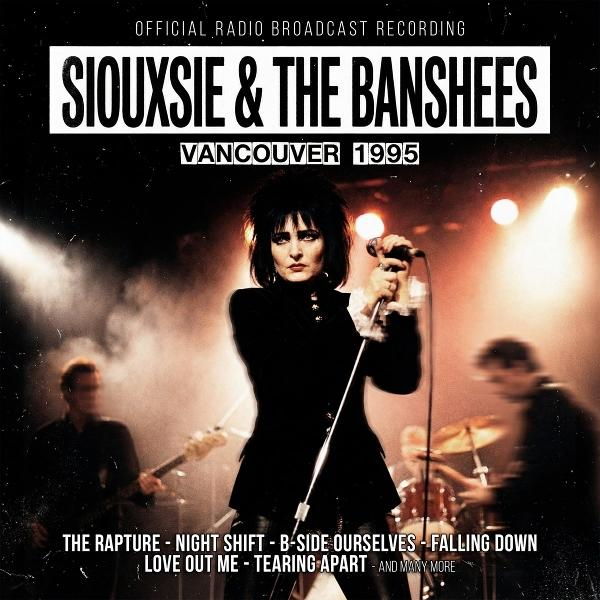 Siouxsie Sioux singt live mit den Banshees vor rauchigem Hintergrund.
