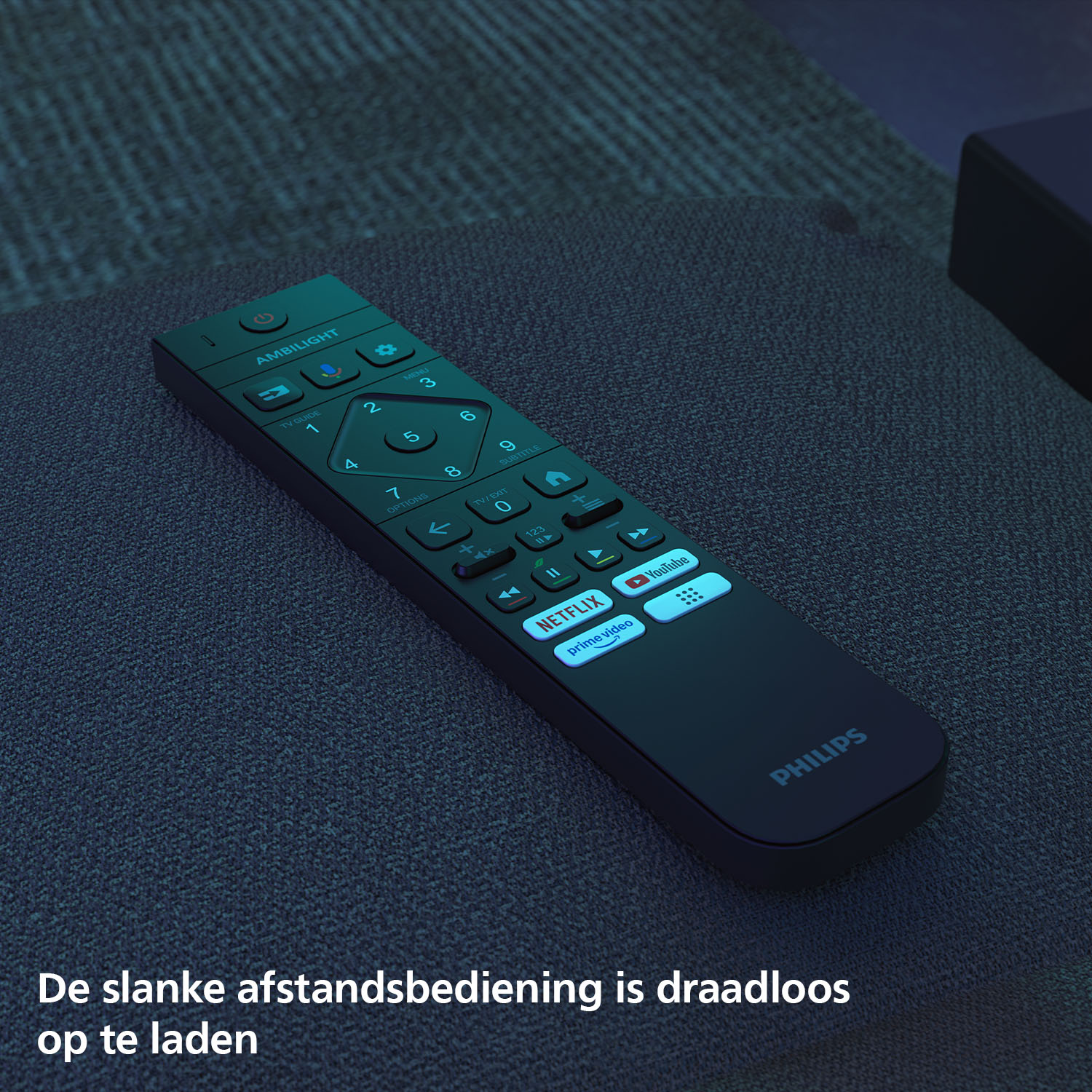 A dark Philips TV remote with Netflix and Prime Video buttons rests on fabric.