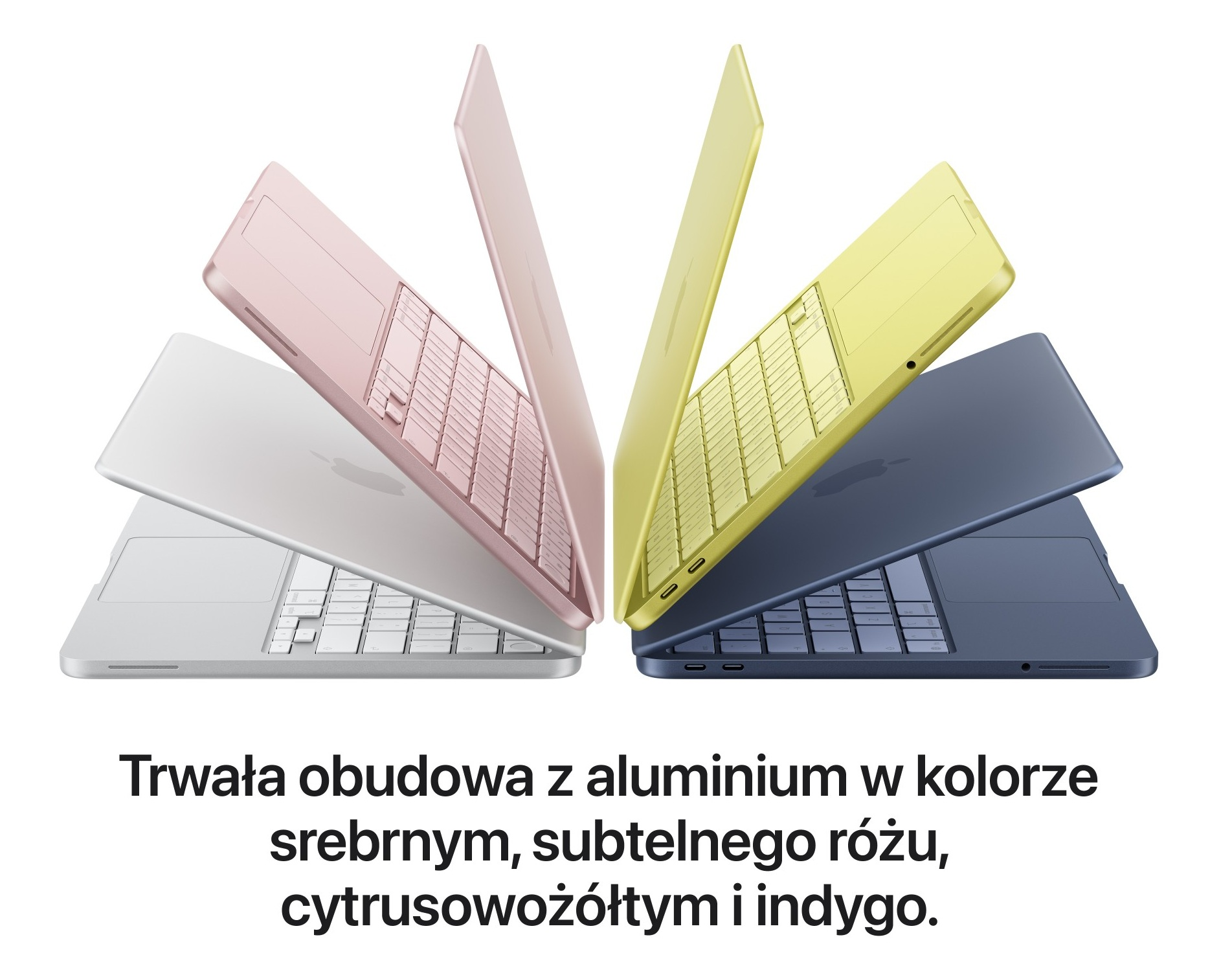 Cztery laptopy w kolorach srebrnym, różowym, żółtym i indygo, z klawiaturą.