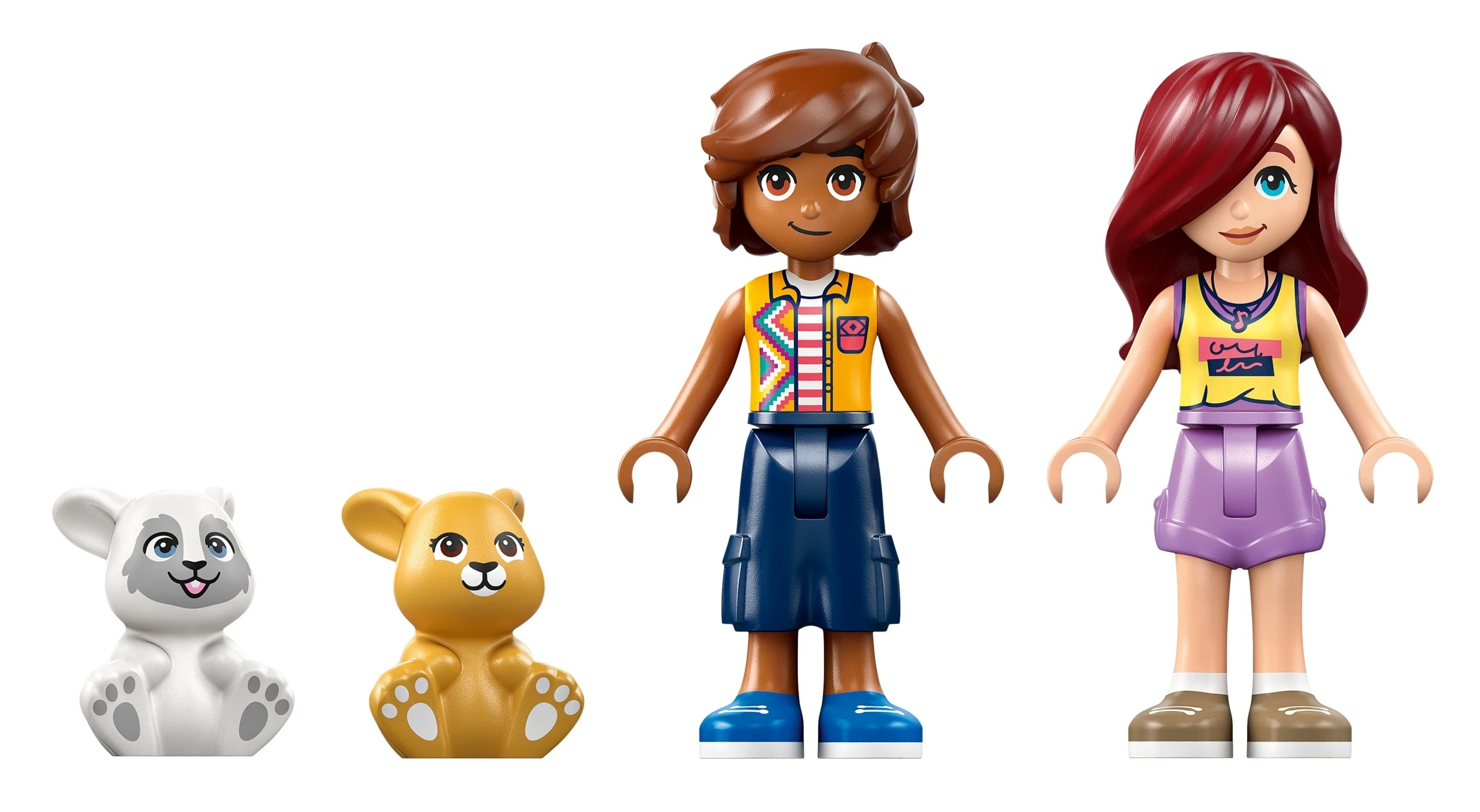 Dwie figurki Lego, biały niedźwiedź polarny i żółty lew, siedzą razem.