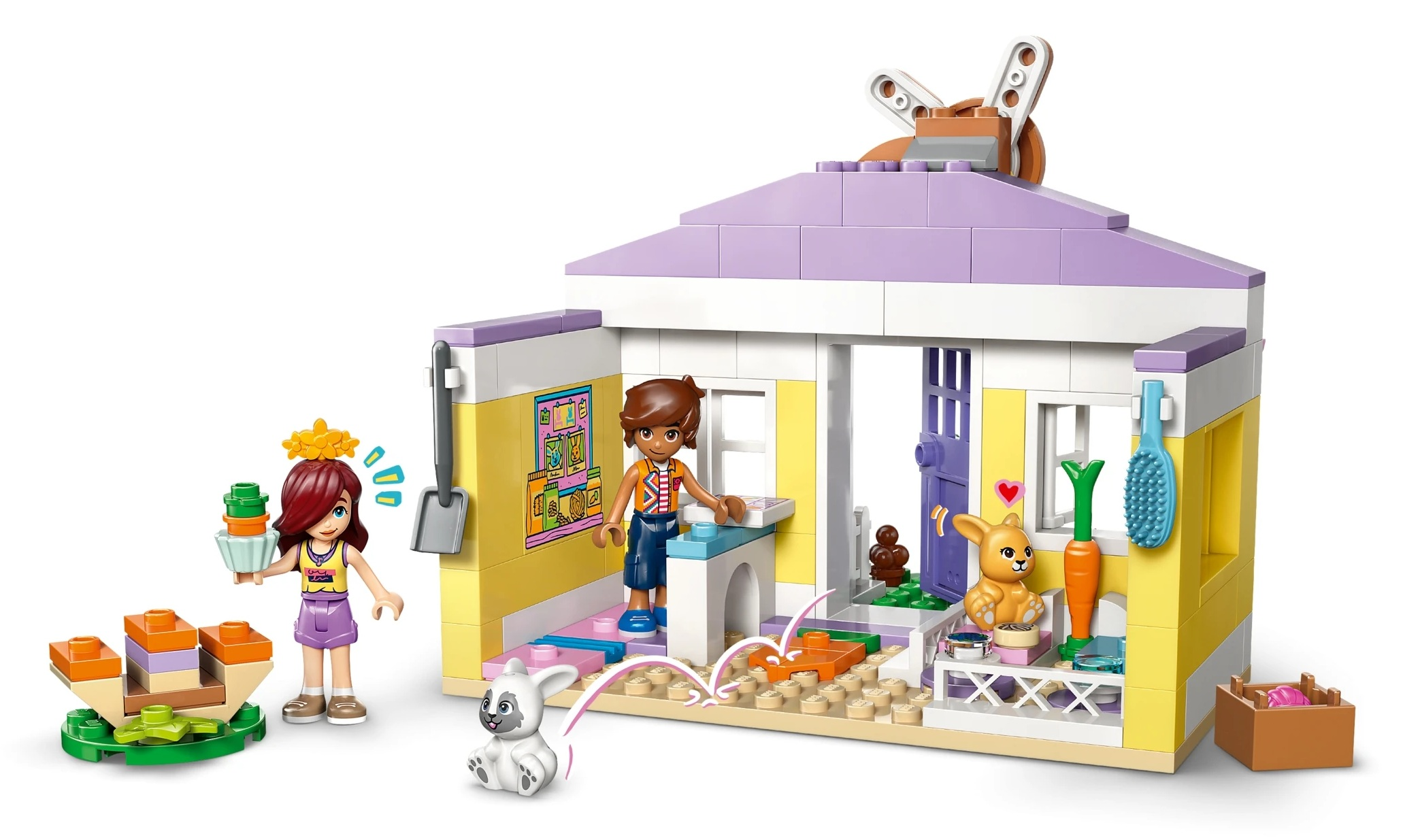 Scena LEGO z dwiema figurkami, królikiem, psem i domkiem.