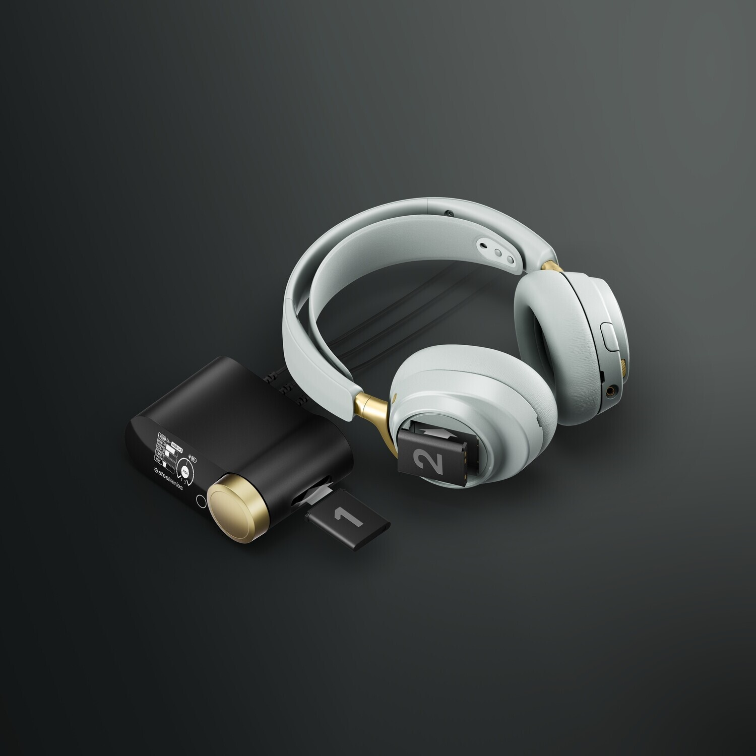 Un auricolare grigio chiaro con accenti dorati accanto a un dongle nero.