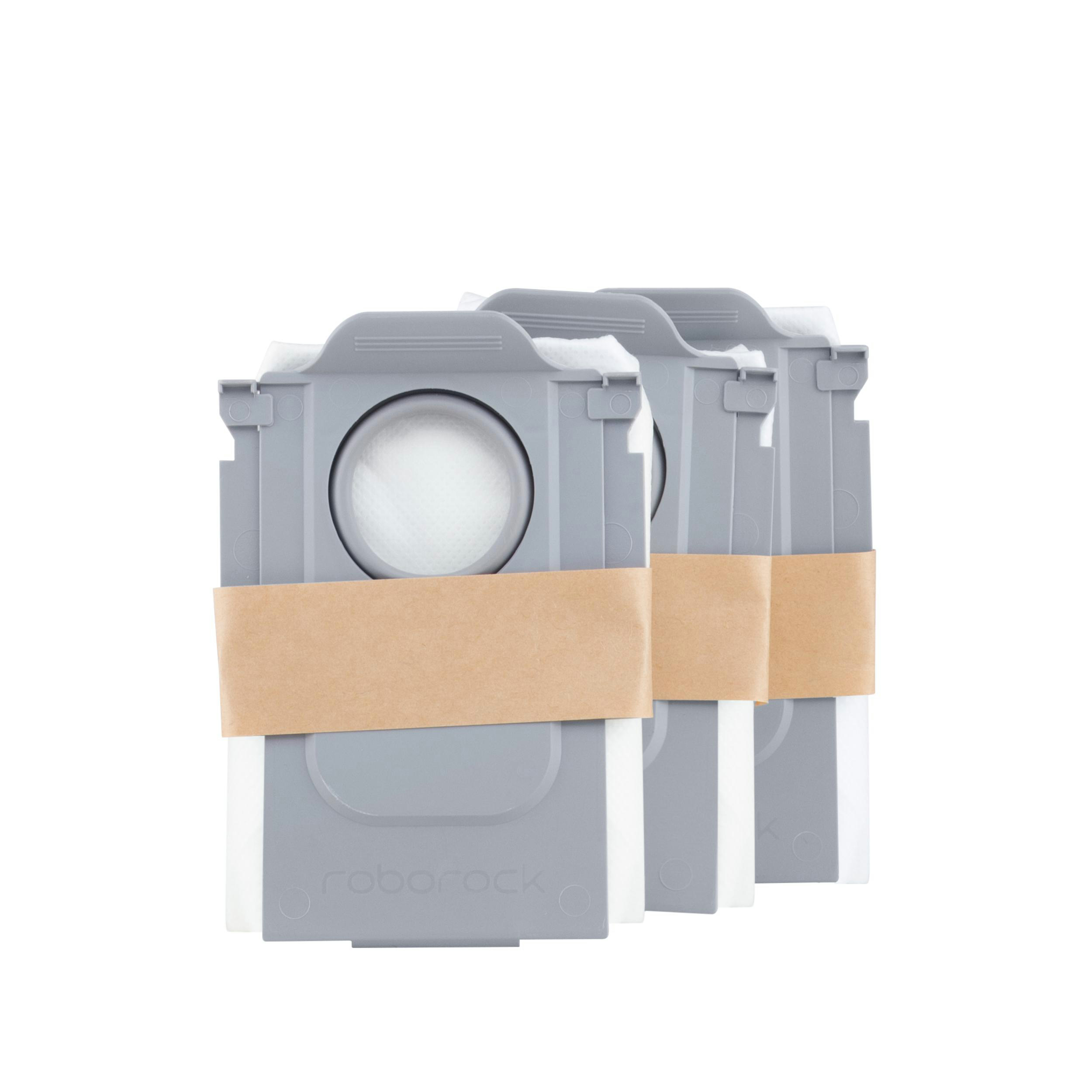 Drei graue Roboterstaubsaugerbeutel, gebündelt mit braunem Papierband.