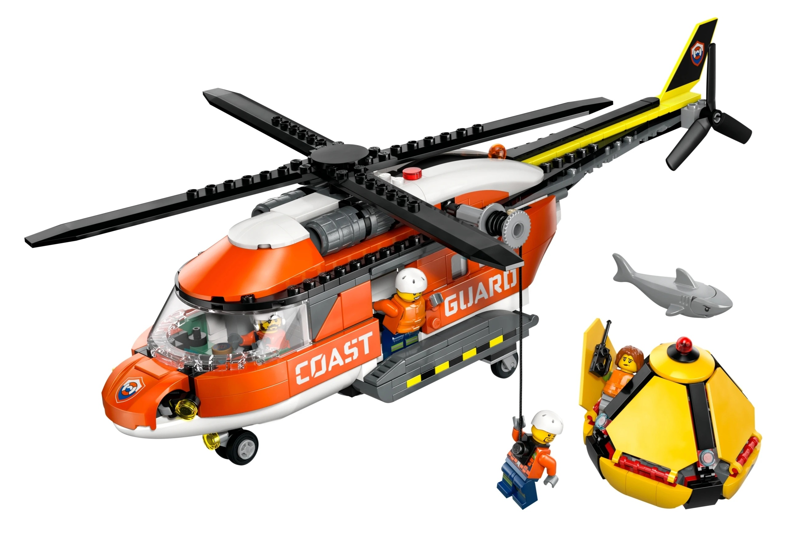 Pomarańczowo-biały helikopter ratunkowy Lego z figurkami, żółtą łodzią podwodną i szarym rekinem.