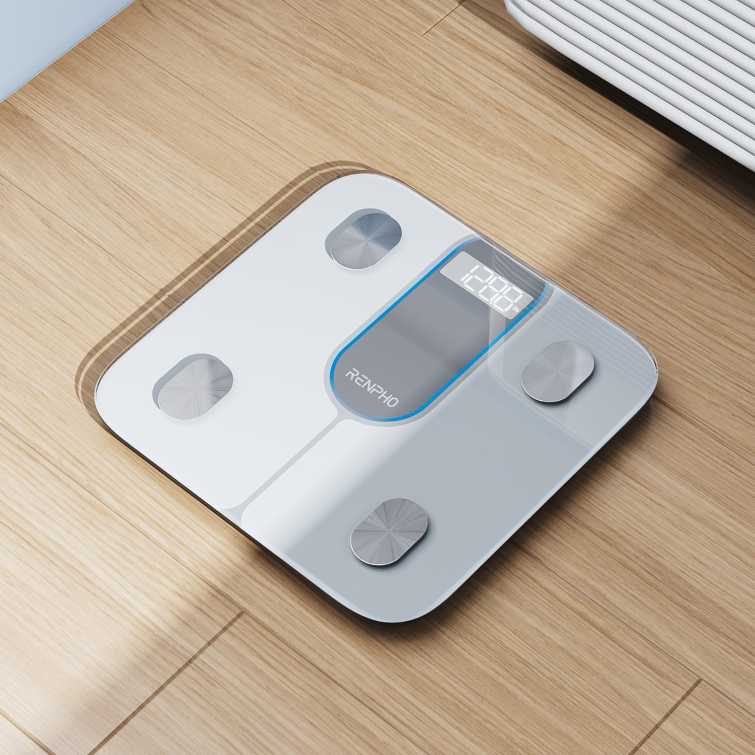 White body scale on a wooden floor with a digital display.