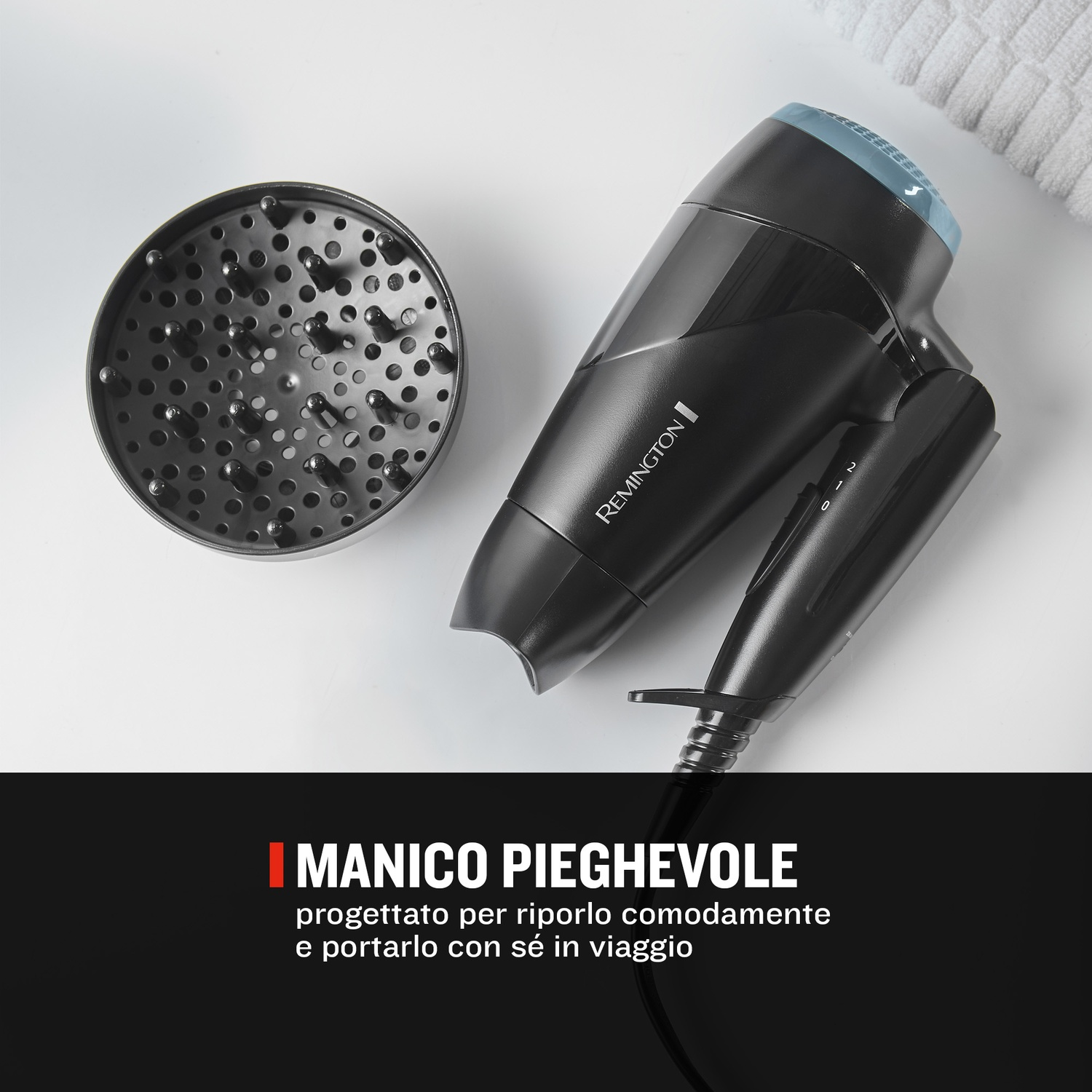 Un asciugacapelli Remington nero con diffusore e asciugamano bianco.