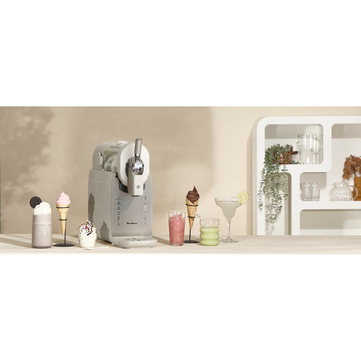 An ice cream maker with ice cream, drinks, and decor on a table.