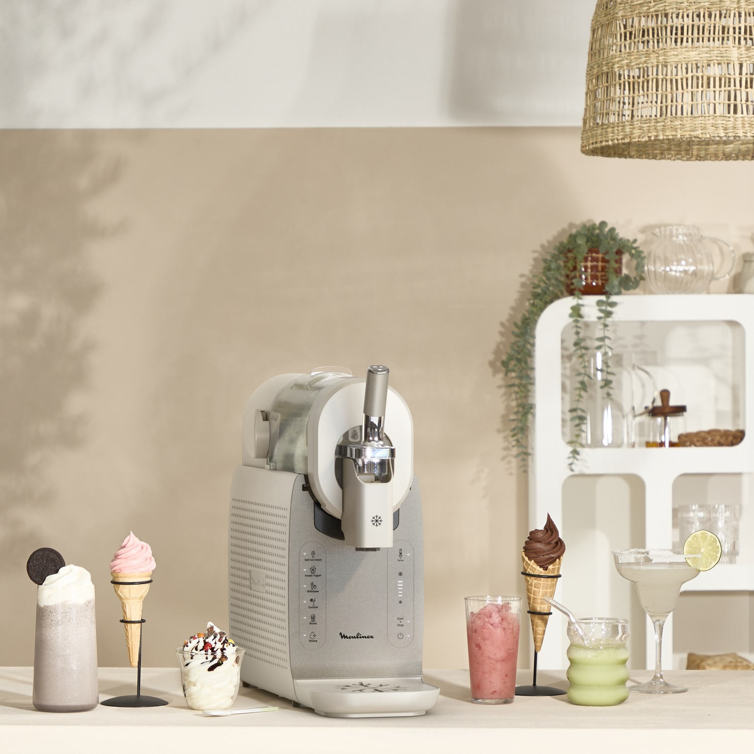 Ice cream maker with ice cream, drinks and a cocktail on a table.