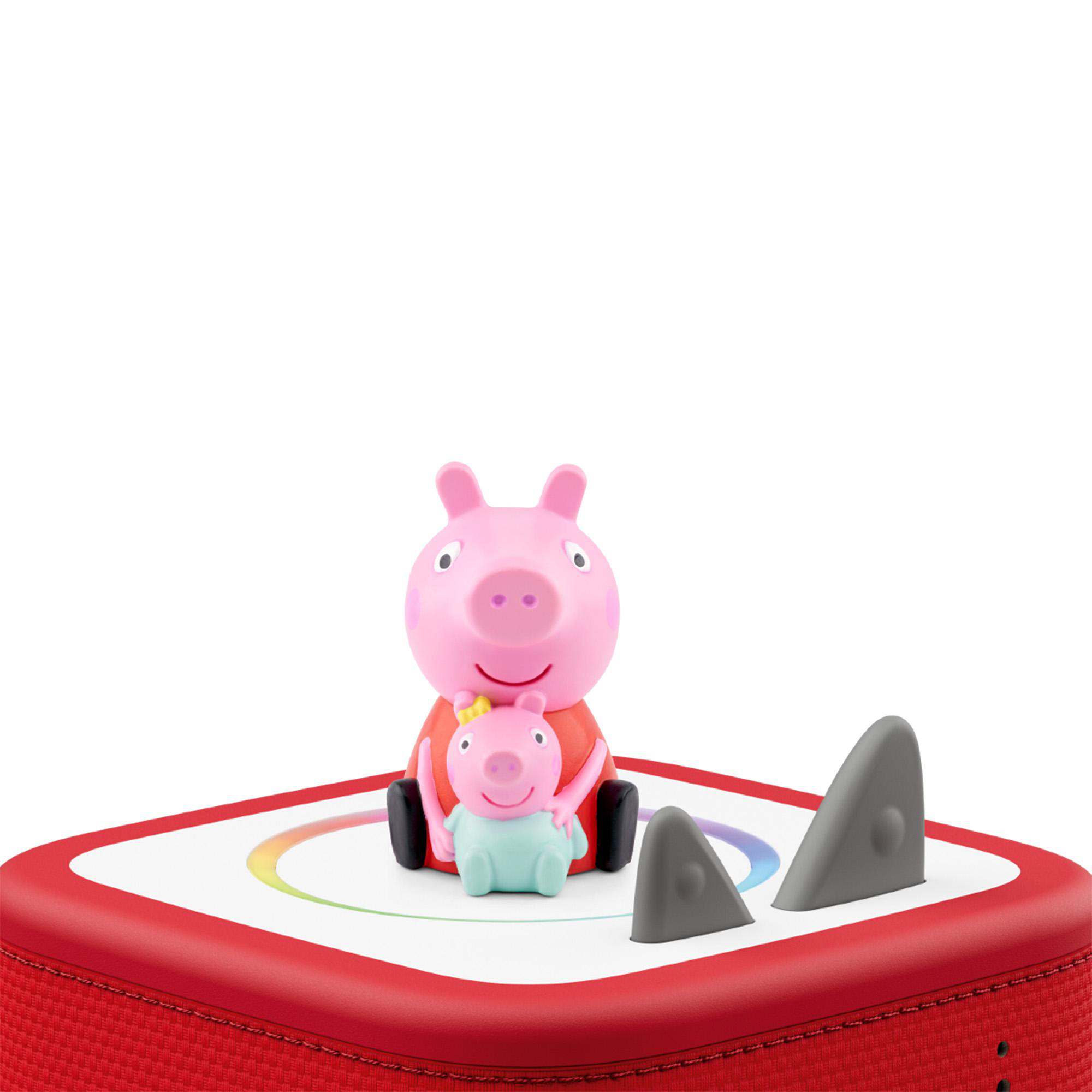 Zwei Peppa Wutz Figuren auf einem roten Lautsprecher mit bunten Lichtern.