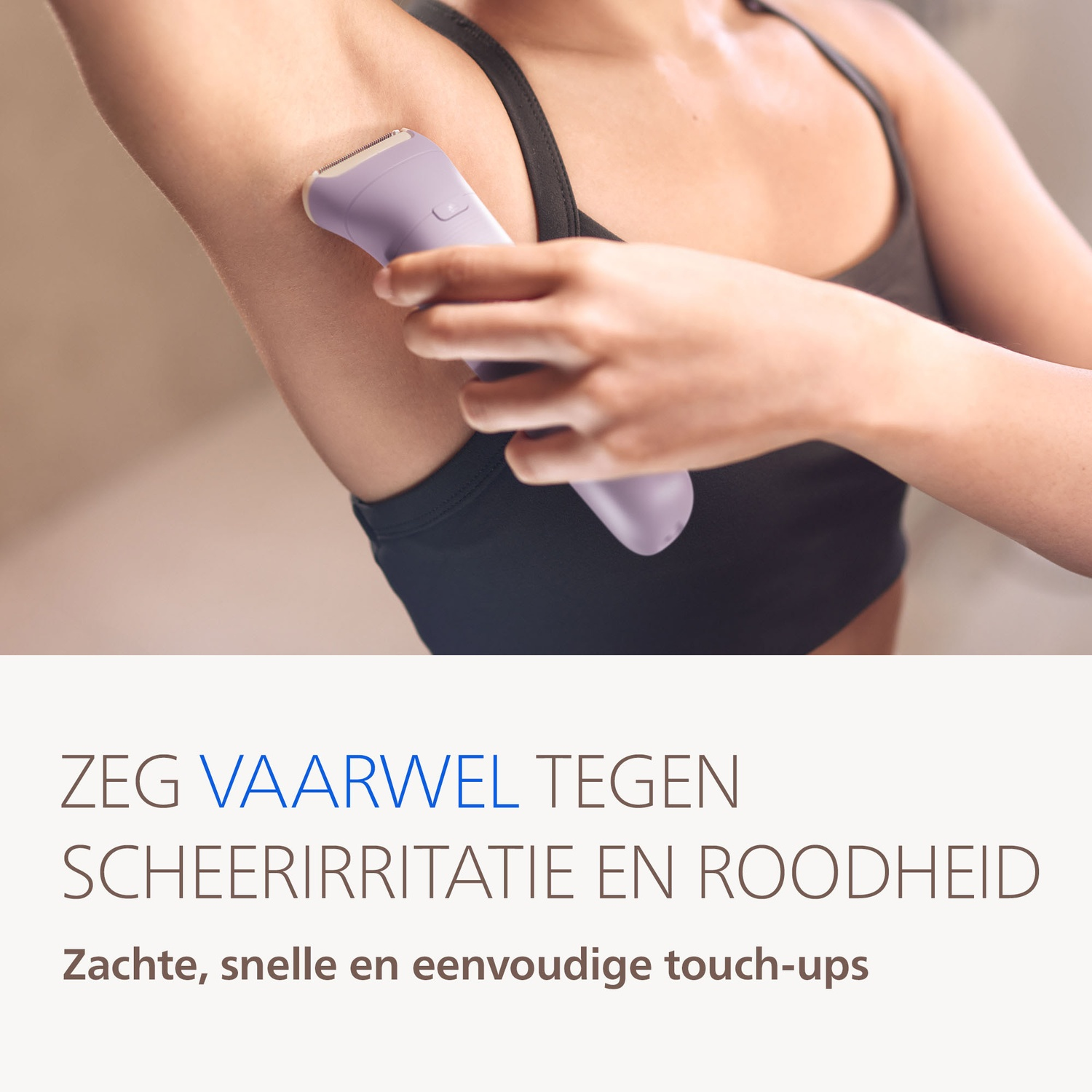 A woman uses a lavender epilator on her underarm.