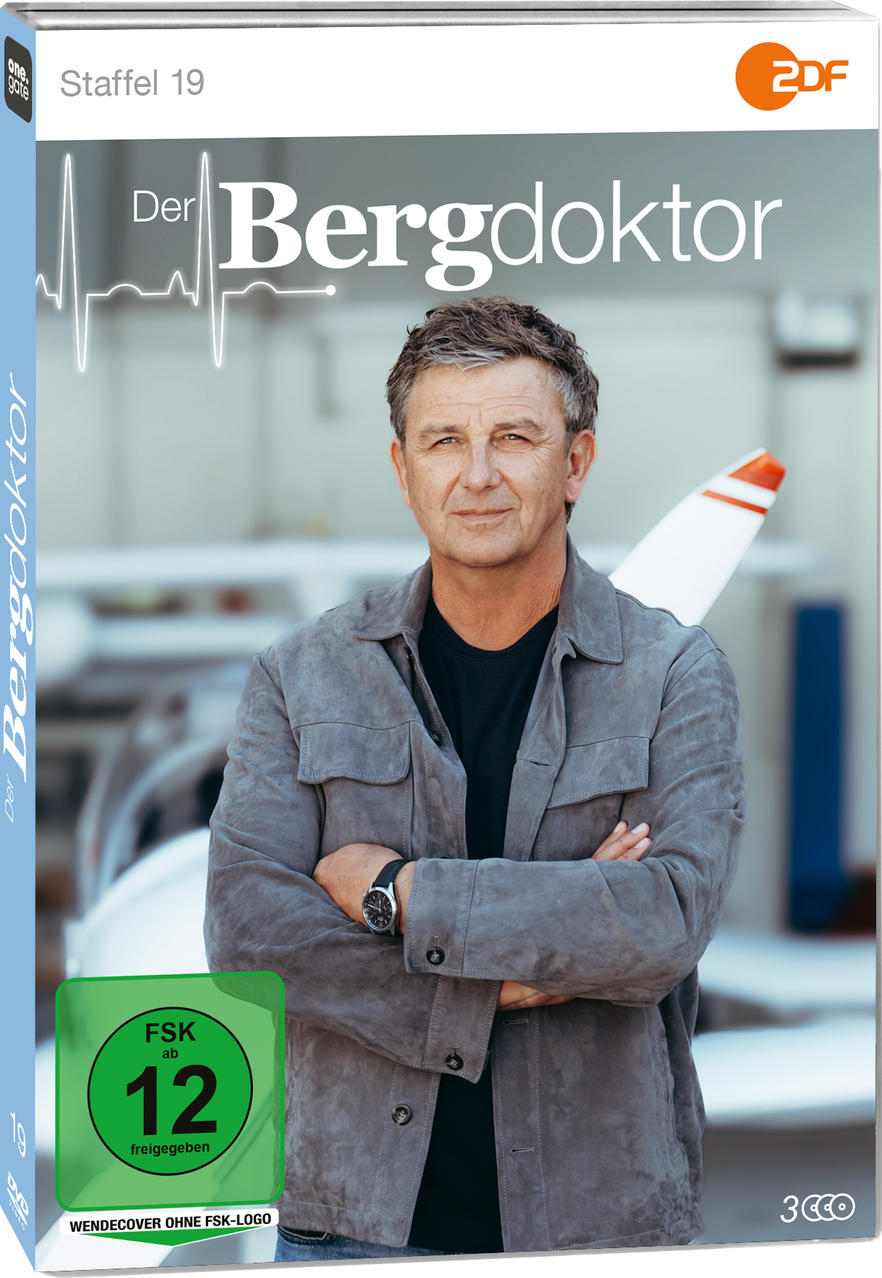Mann in grauer Jacke vor Flugzeug, Staffel 19 von Der Bergdoktor.