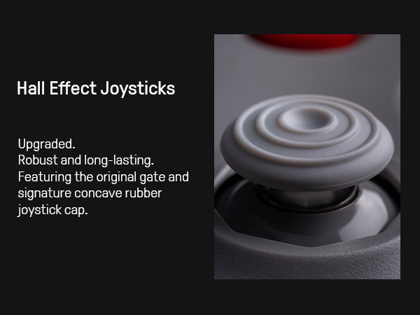 Grauer Joystick mit Ringen und konkavem Gummikappe. Roter Kreis oben.