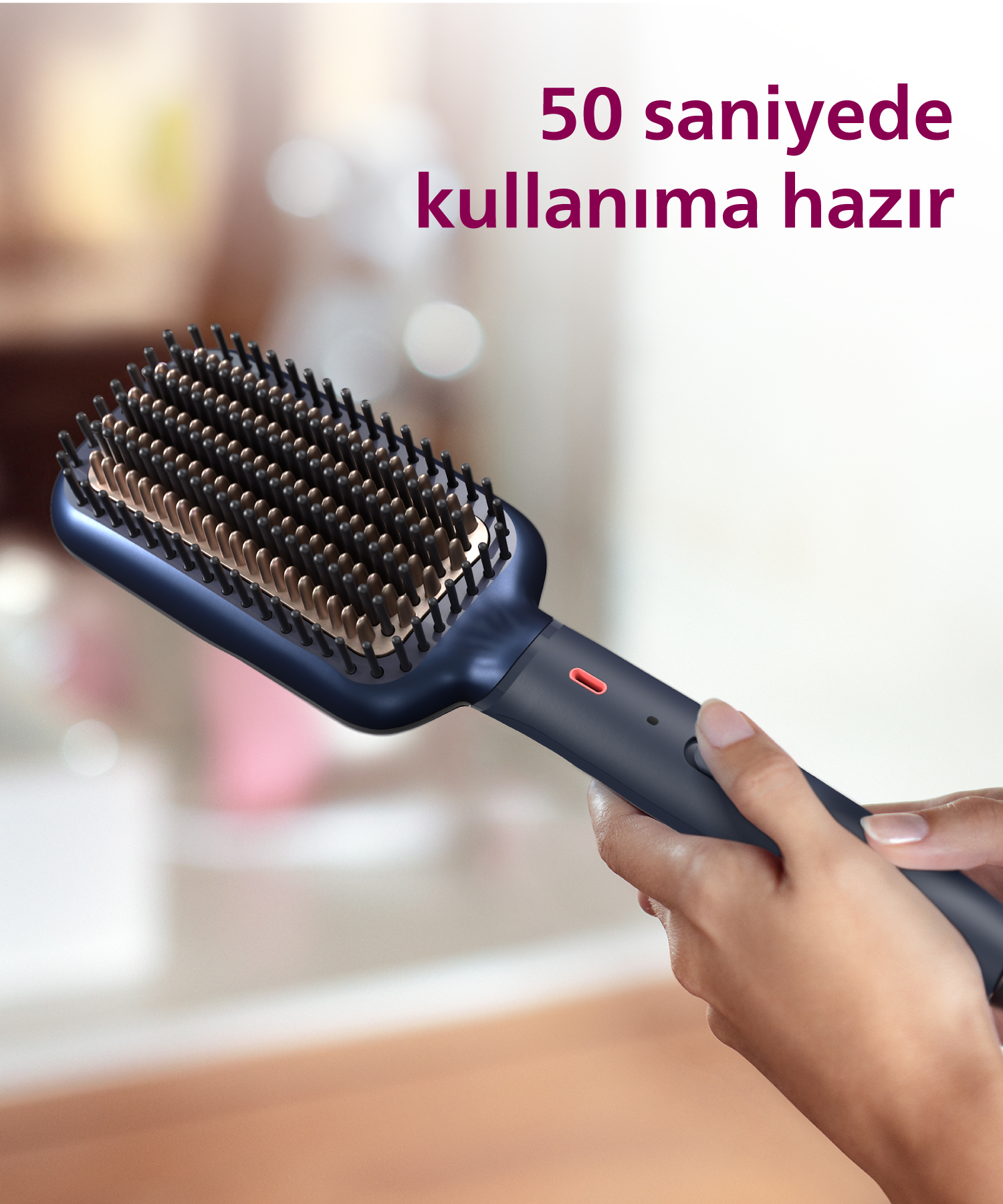 Bir kişi altın rengi kıllara sahip lacivert bir saç düzleştirici tarak tutuyor. 50 sn.