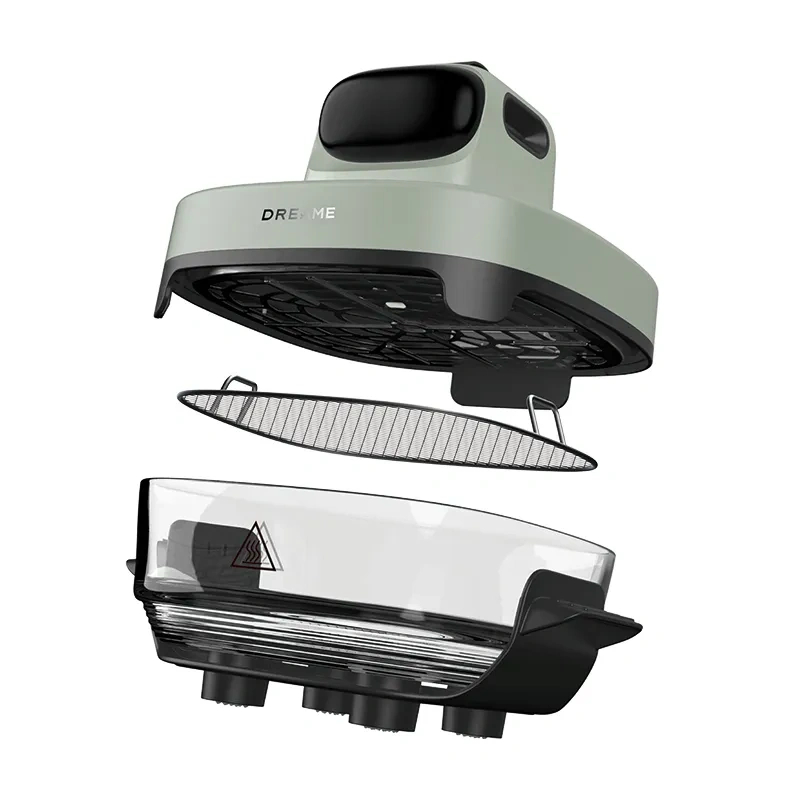 Rozłożony jasnozielony i czarny parowar ze szklanym pojemnikiem i metalowym filtrem.