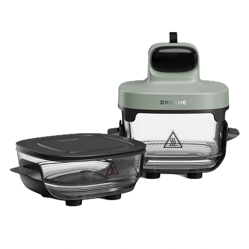 Dwa szklane pojemniki z czarnymi pokrywkami, zielona nakładka frytkownicy.