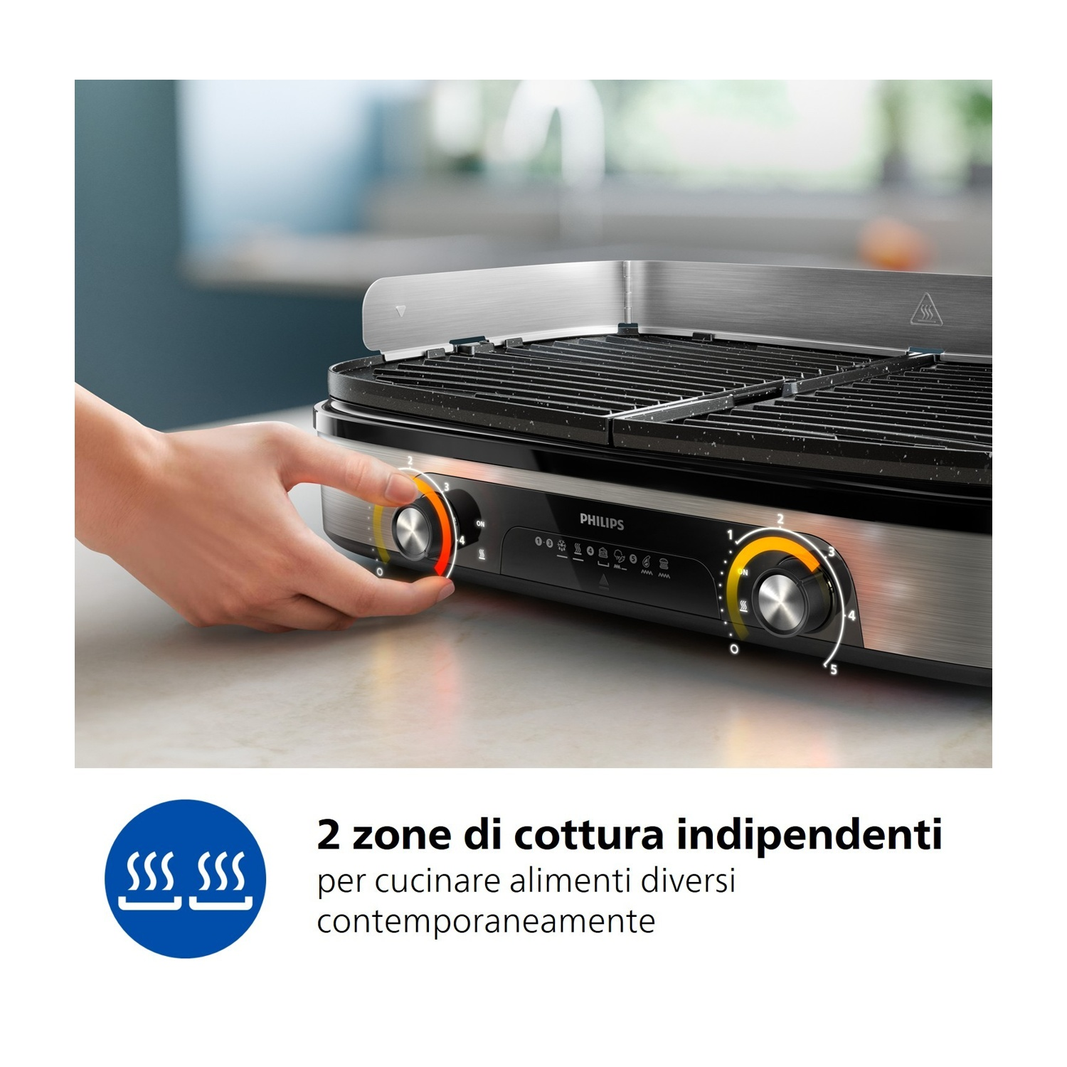 Una mano gira una manopola su una griglia Philips argentata a due zone.