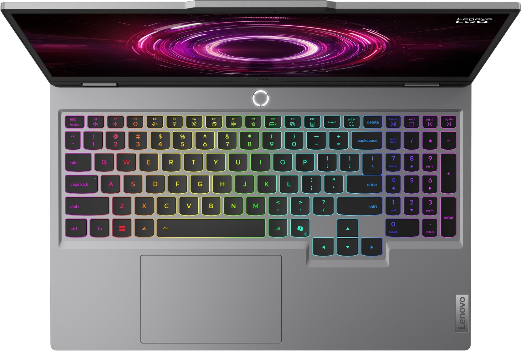 Un ordinateur portable gris ouvert avec clavier rétroéclairé et design circulaire à l'écran.