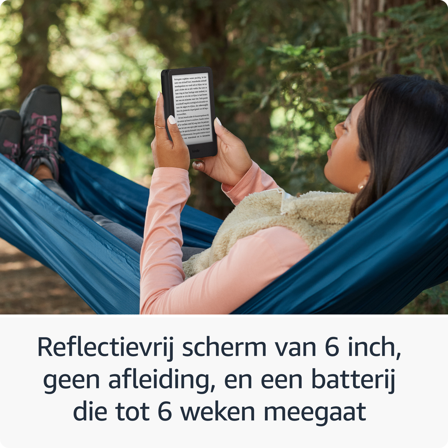 A woman reclines in a hammock, reading an e-book outdoors.