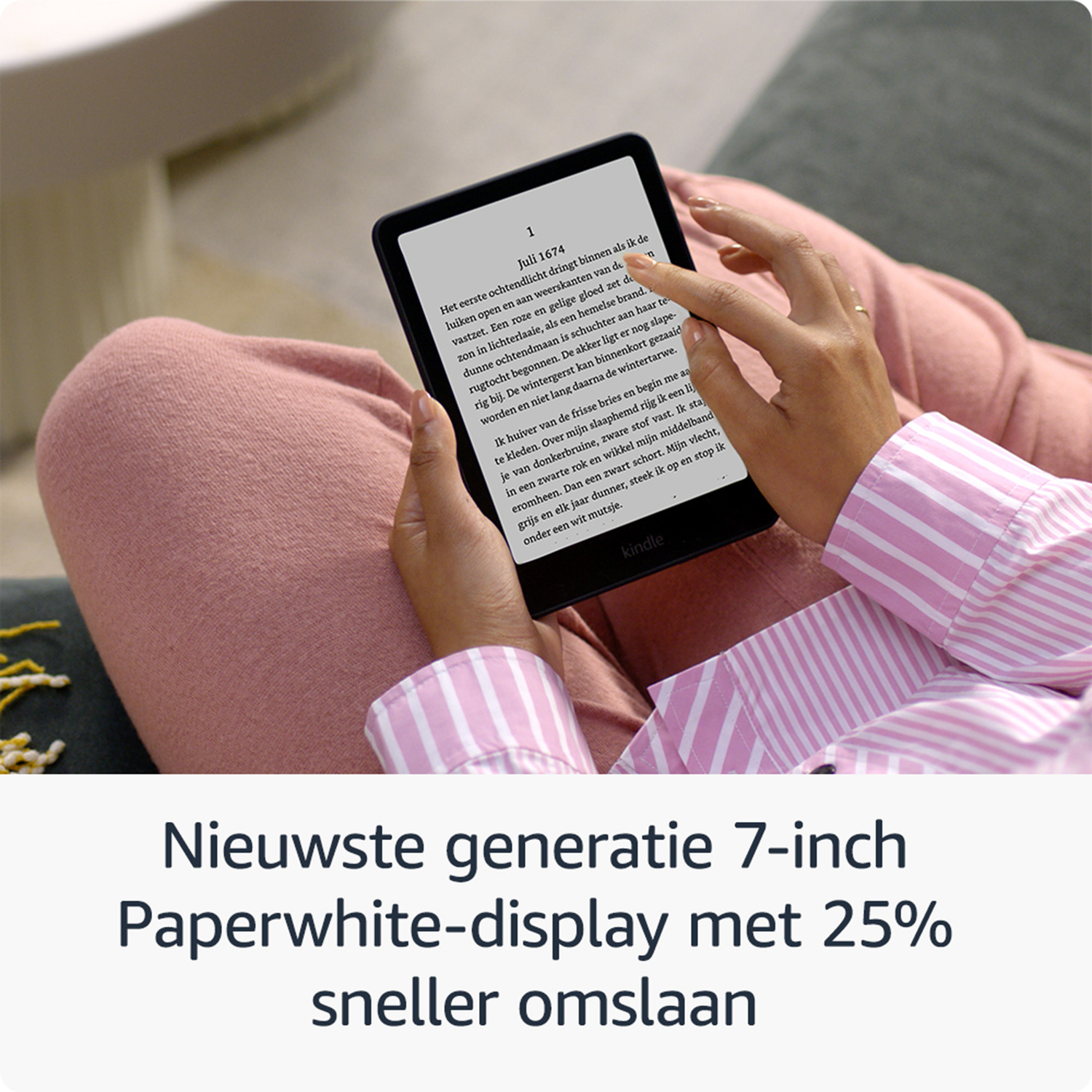 A person holds a Kindle Paperwhite. Text is displayed on the screen.