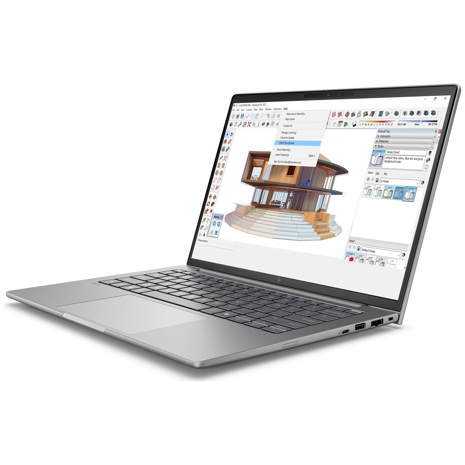 A laptop displays a 3D architectural visualization in SketchUp.