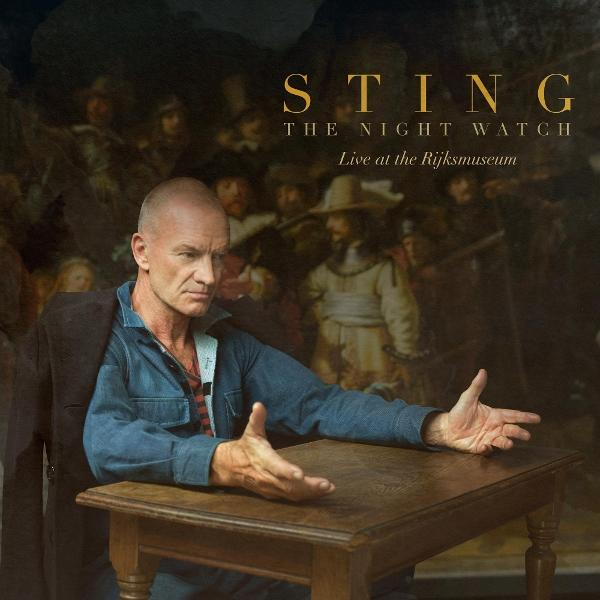 Sting sitzt an einem Holztisch vor Rembrandts Nachtwache.