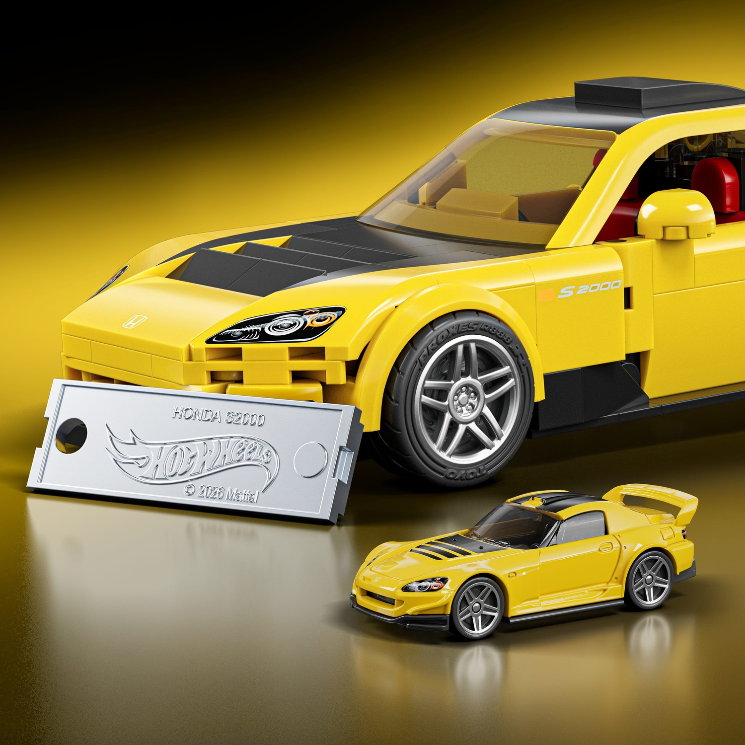 Una Honda S2000 gialla Lego e una macchinina più piccola davanti.