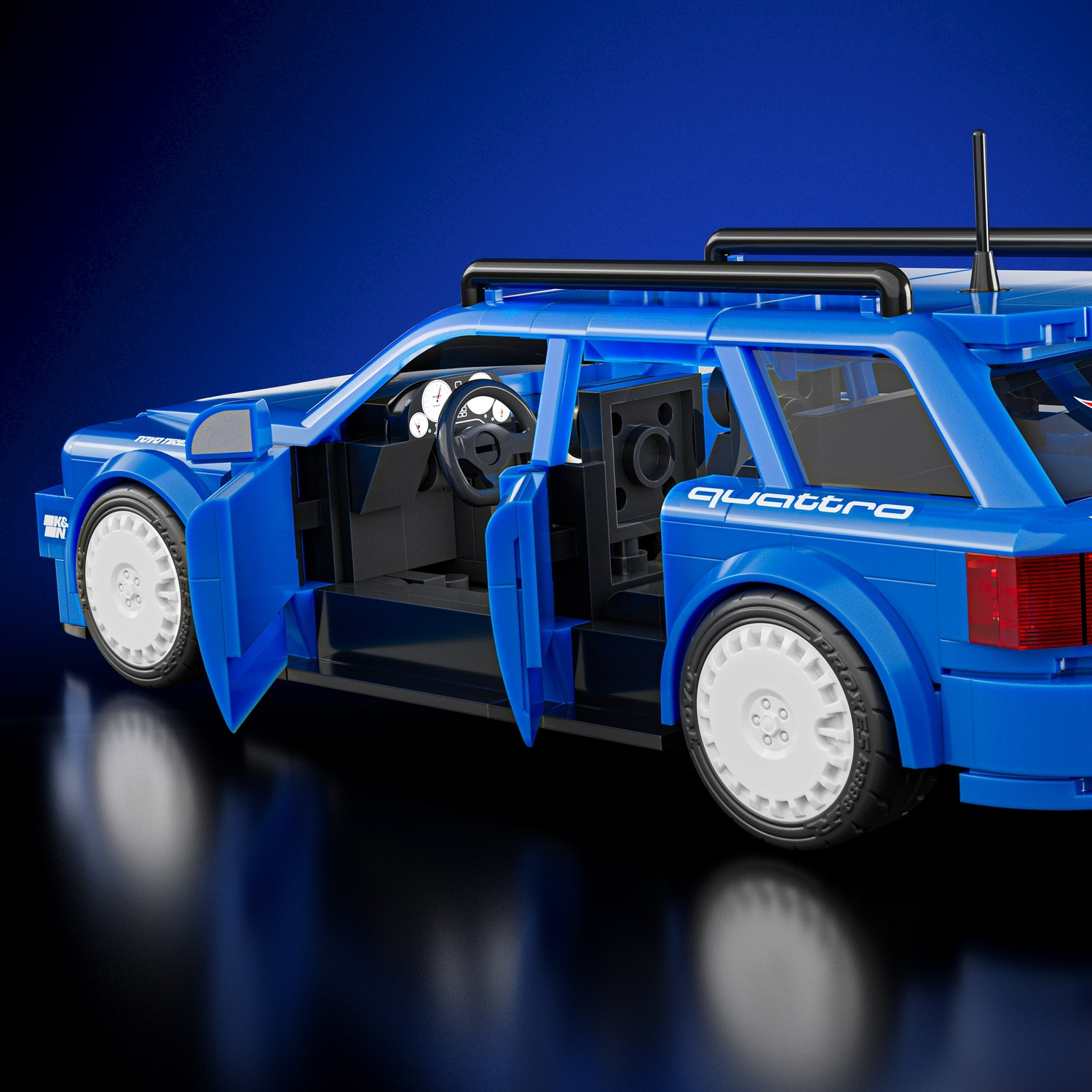 Audi Lego blu con porte aperte, ruote bianche e portapacchi.