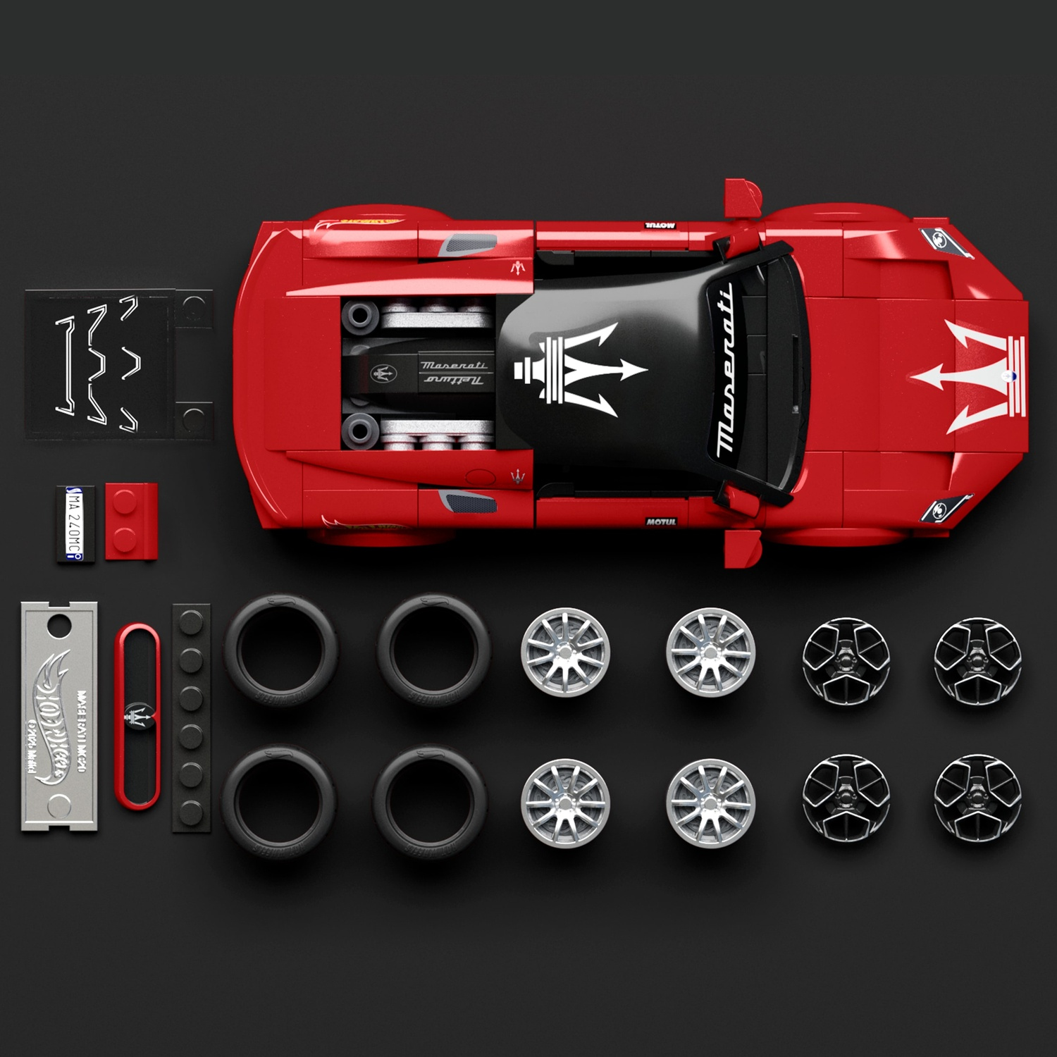 Un modello rosso Lego Maserati con accessori come pneumatici e ruote su sfondo nero.