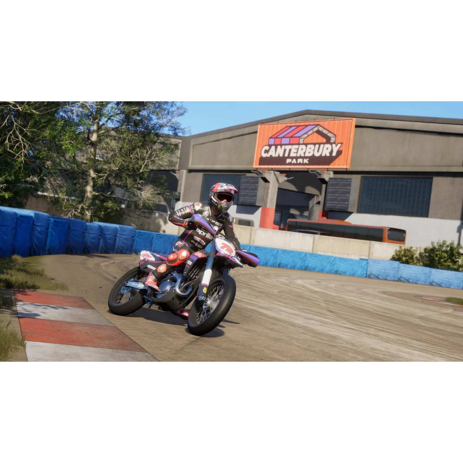 Motorcyclist on a race track with Canterbury Park sign in the background.