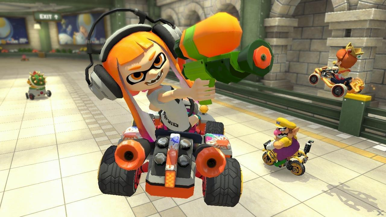 Inkling w gokarcie ze Splattershotem, Wario i Daisy ścigają się.
