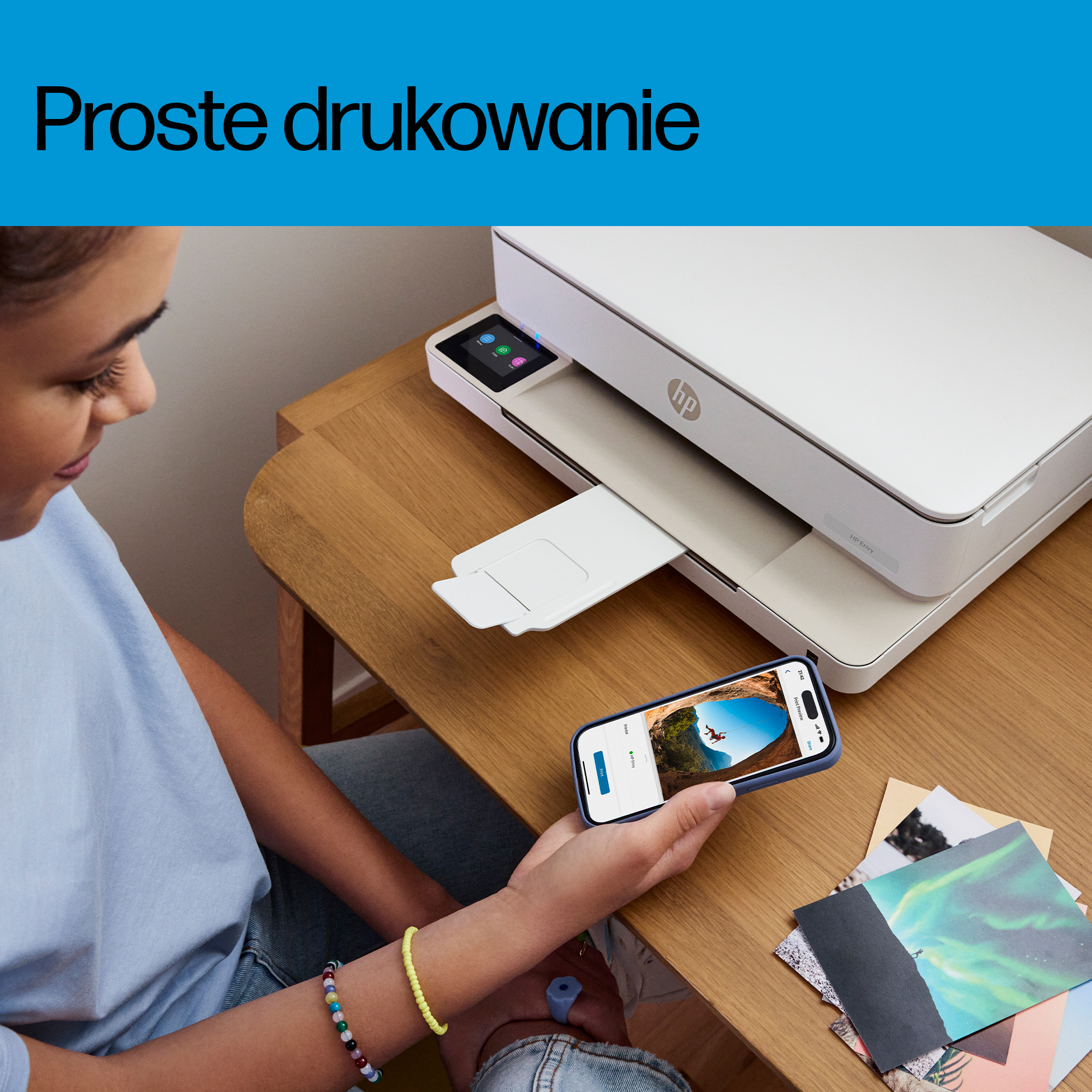 Młoda kobieta trzyma smartfona i drukuje zdjęcia z drukarki HP.