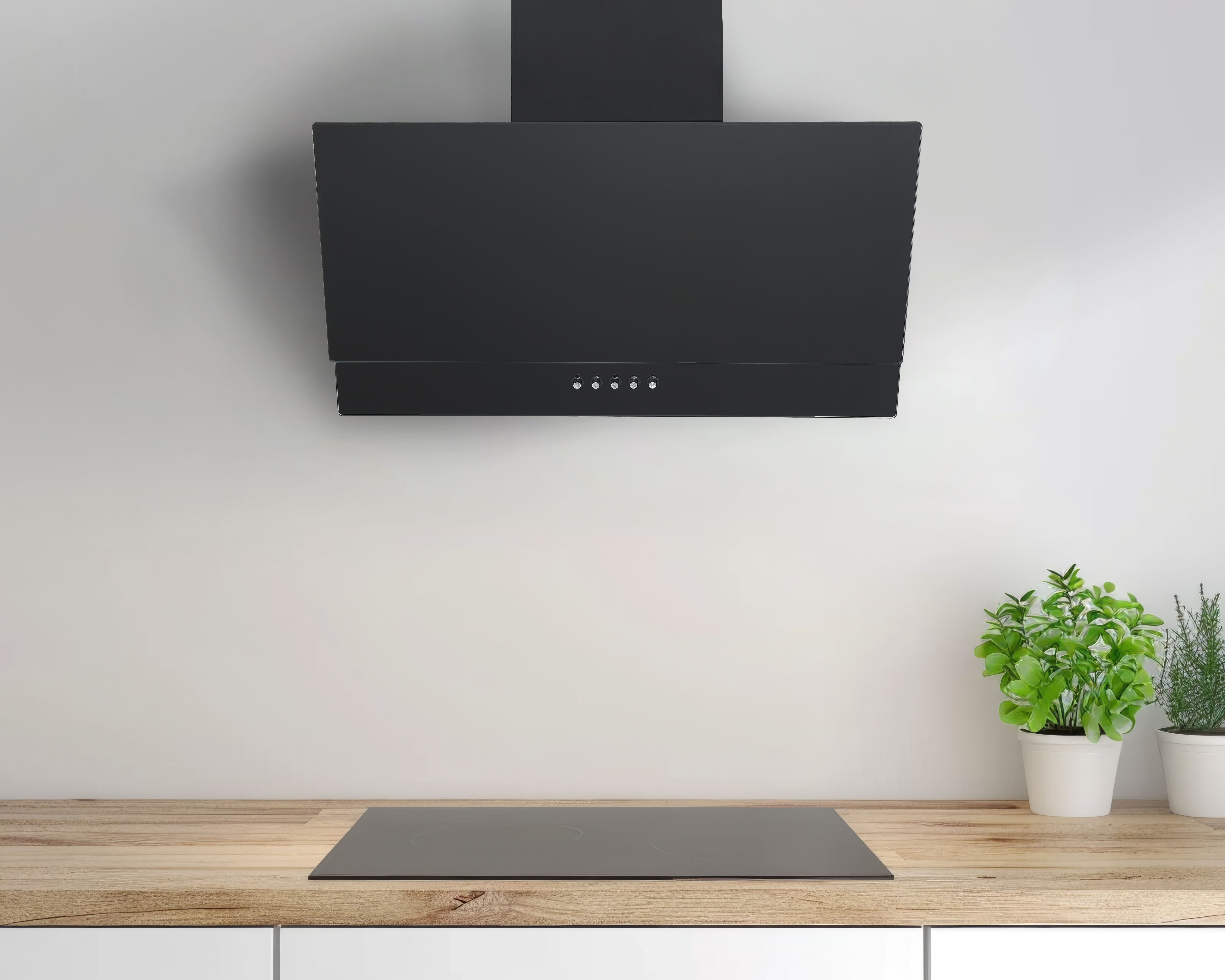 Czarna okap nad płytą grzewczą na drewnianym blacie z roślinami.