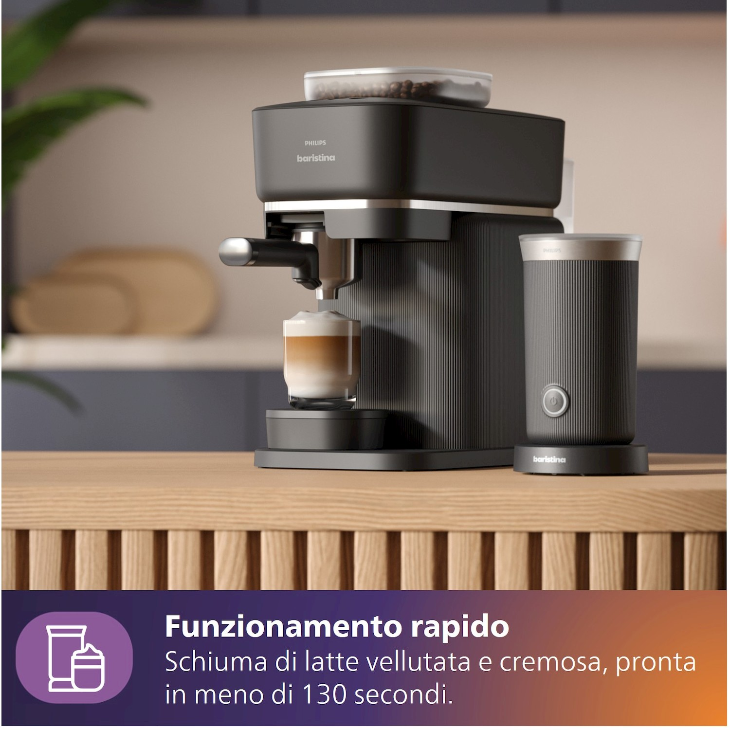 Una macchina da caffè Philips Baristina nera con montalatte e un bicchiere di caffè.
