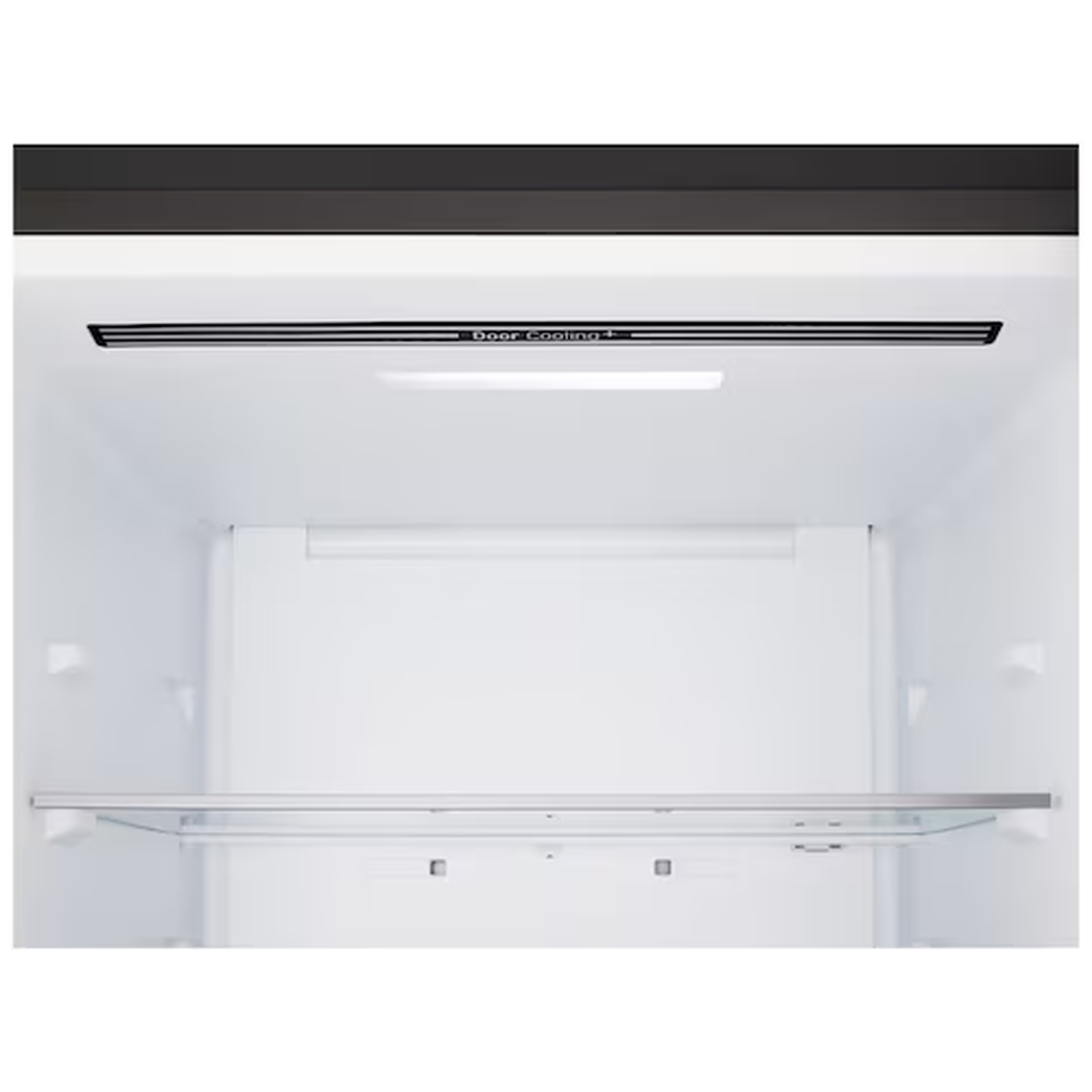 Interior view of an empty refrigerator with a glass shelf and cooling vents.