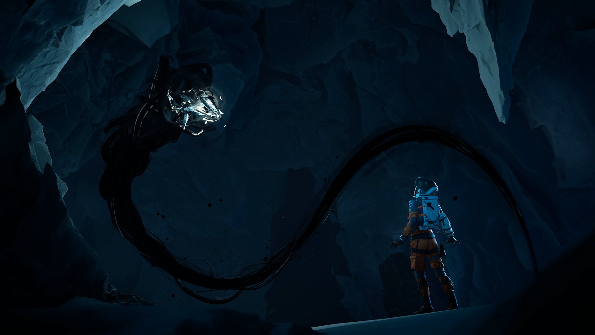 Un astronaute se tient devant une créature sombre et tentaculaire dans une grotte glacée.