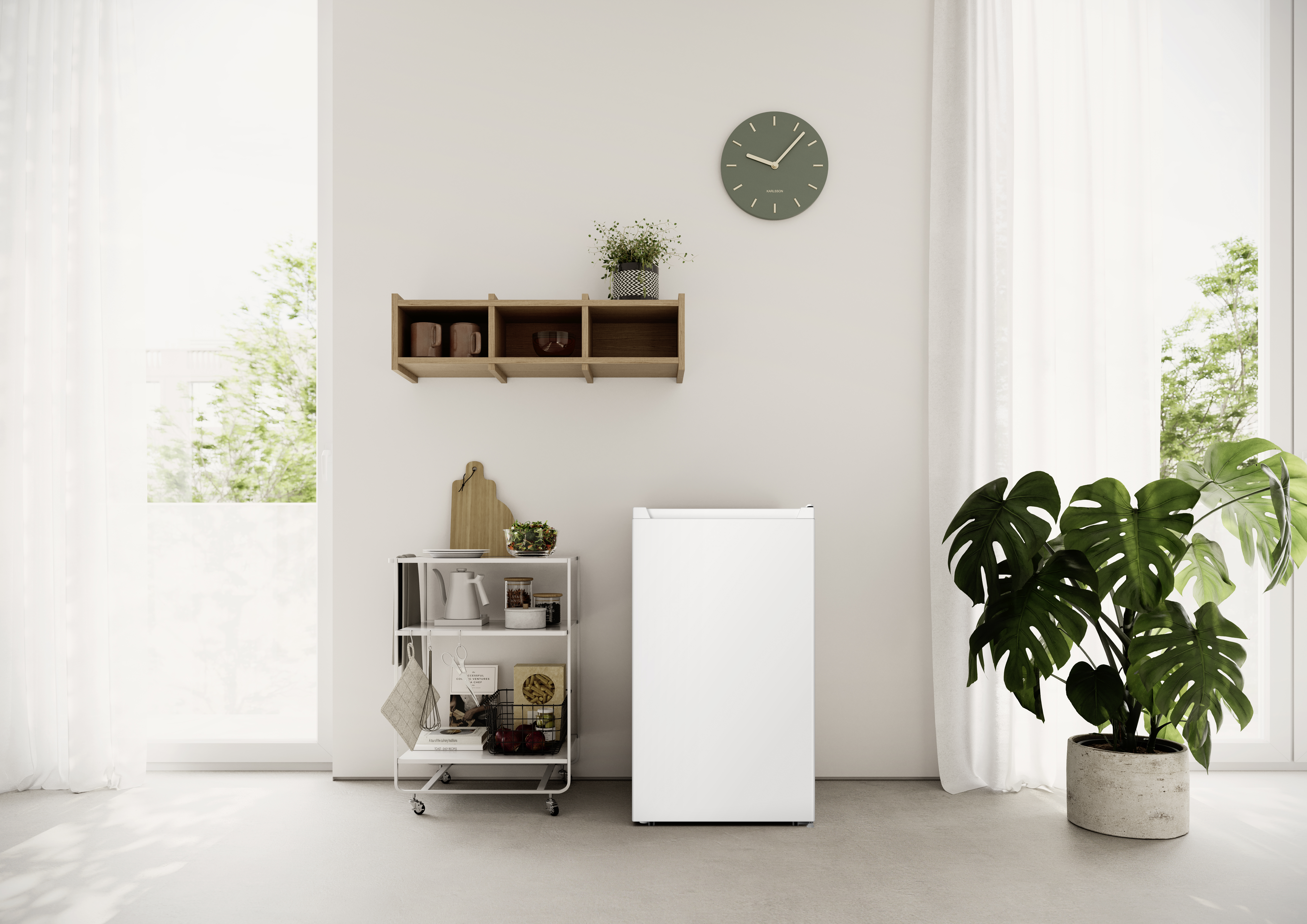 Una nevera blanca junto a un carrito de cocina con comestibles. Una planta de Monstera cerca.